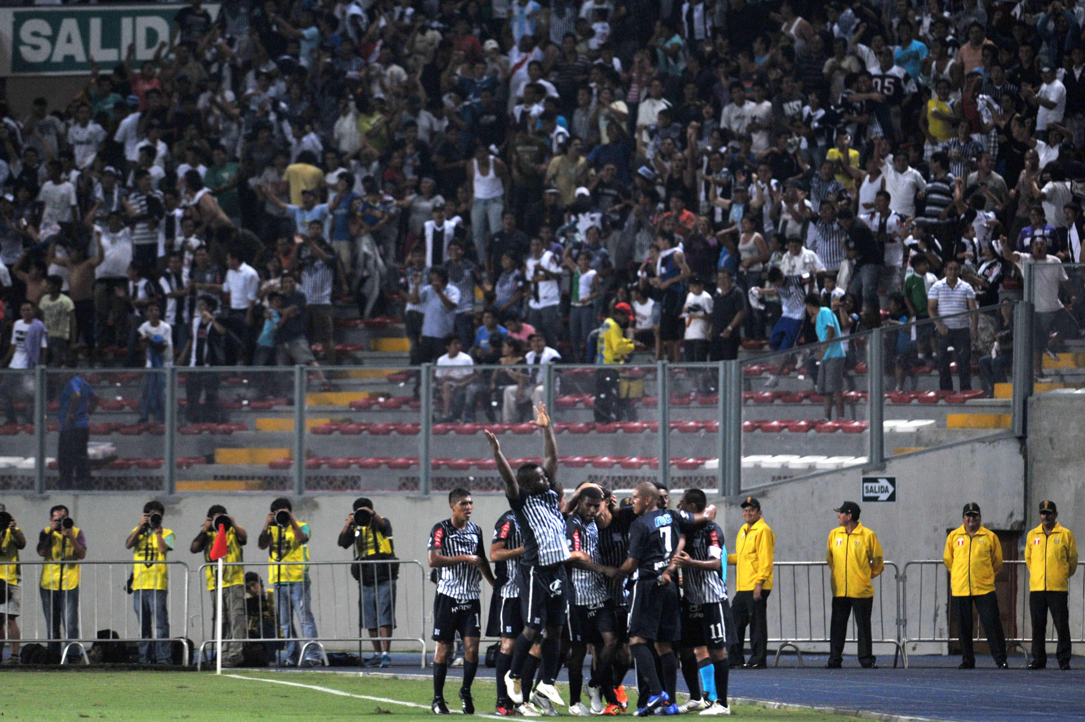 Alianza Lima players and fans celebrate a goal