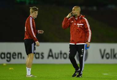 Bayern Munich midfielder Toni Kroos and coach Pep Guardiola