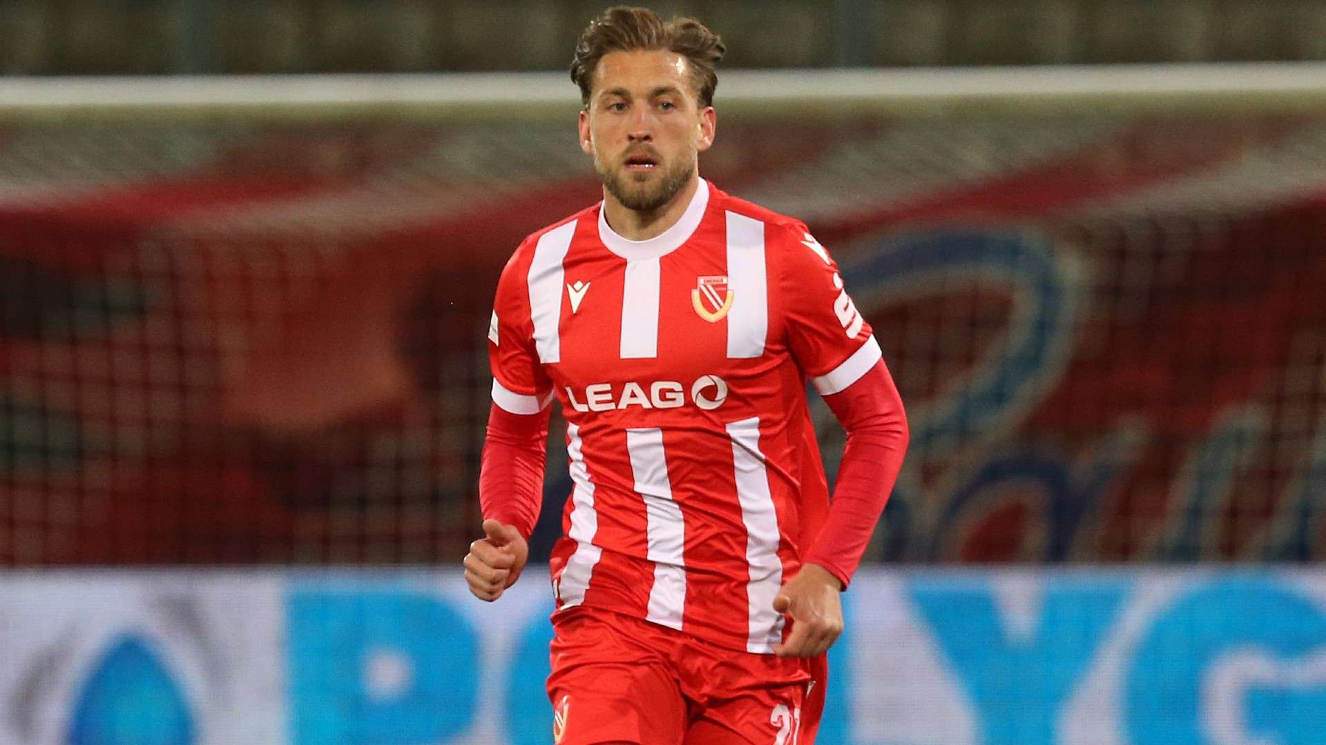 Dennis Slamar of Cottbus runs with the ball