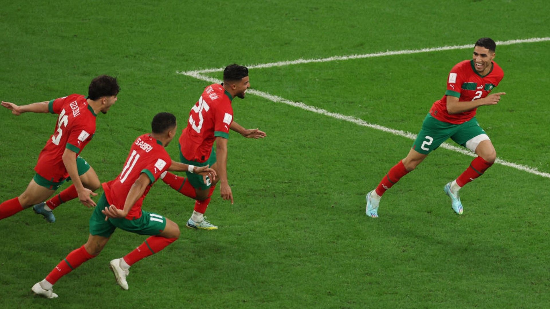 Morocco players celebrate Achraf Hakimi's winning penalty.