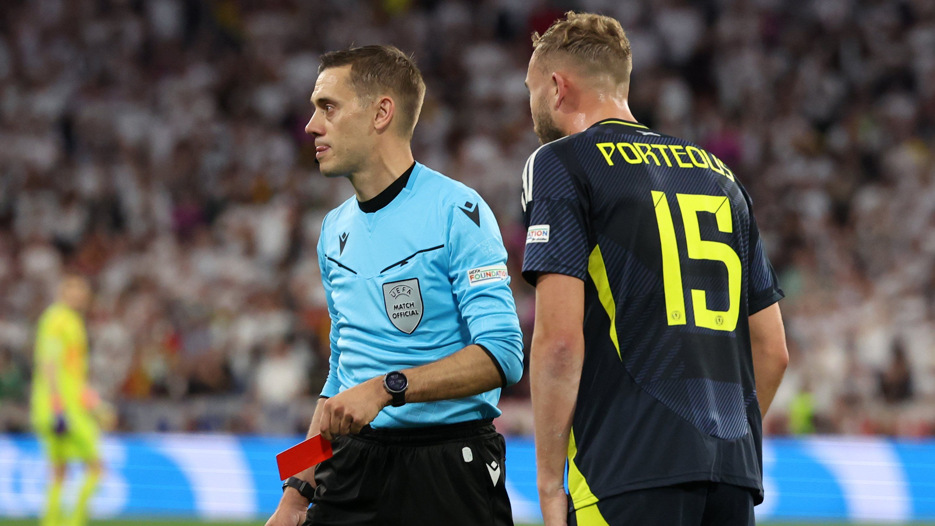 Referee Clement Turpin shows a red card to Ryan Porteous of Scotland