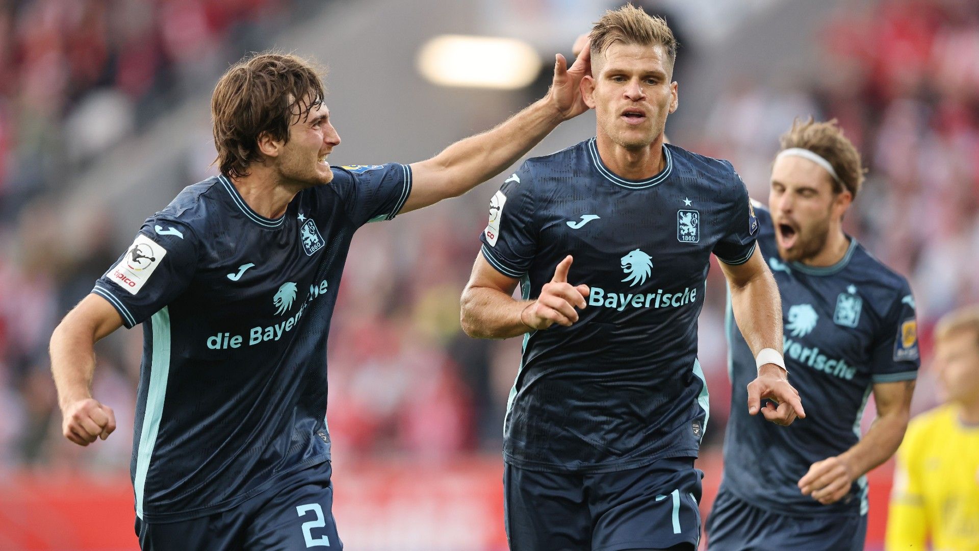 Florian Niederlechner of TSV 1860 München celebrates the first goal with Tim Danhof (L)