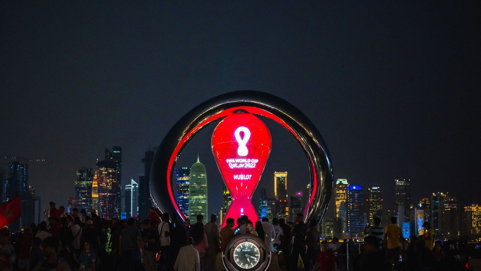 People gather for photos around the World Cup countdown clock in Doha