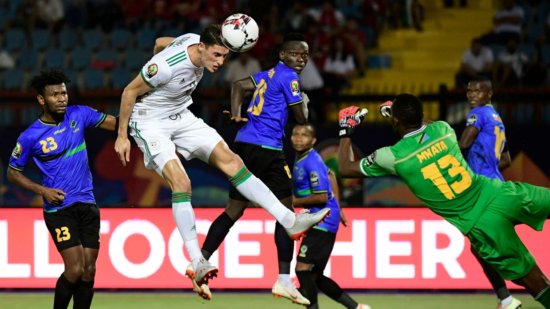 Algeria's Mehdi Tahrat (2nd-L) vies for the ball with Tanzania's goalkeeper Metacha Mnata (R)
