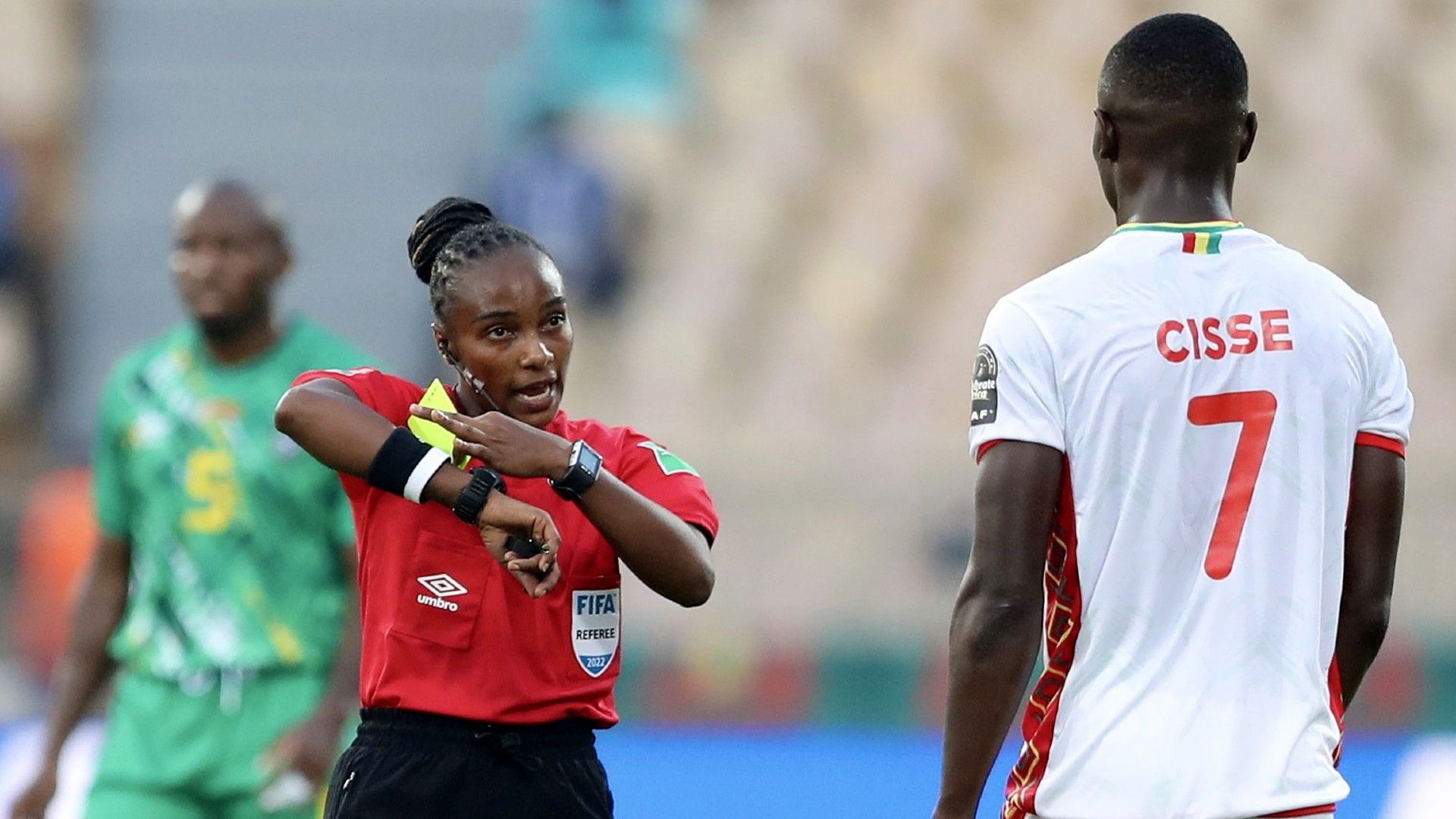  Referee Salima Rhadia Mukansanga of Rwanda talks to Ibrahima Cisse of Guinea.