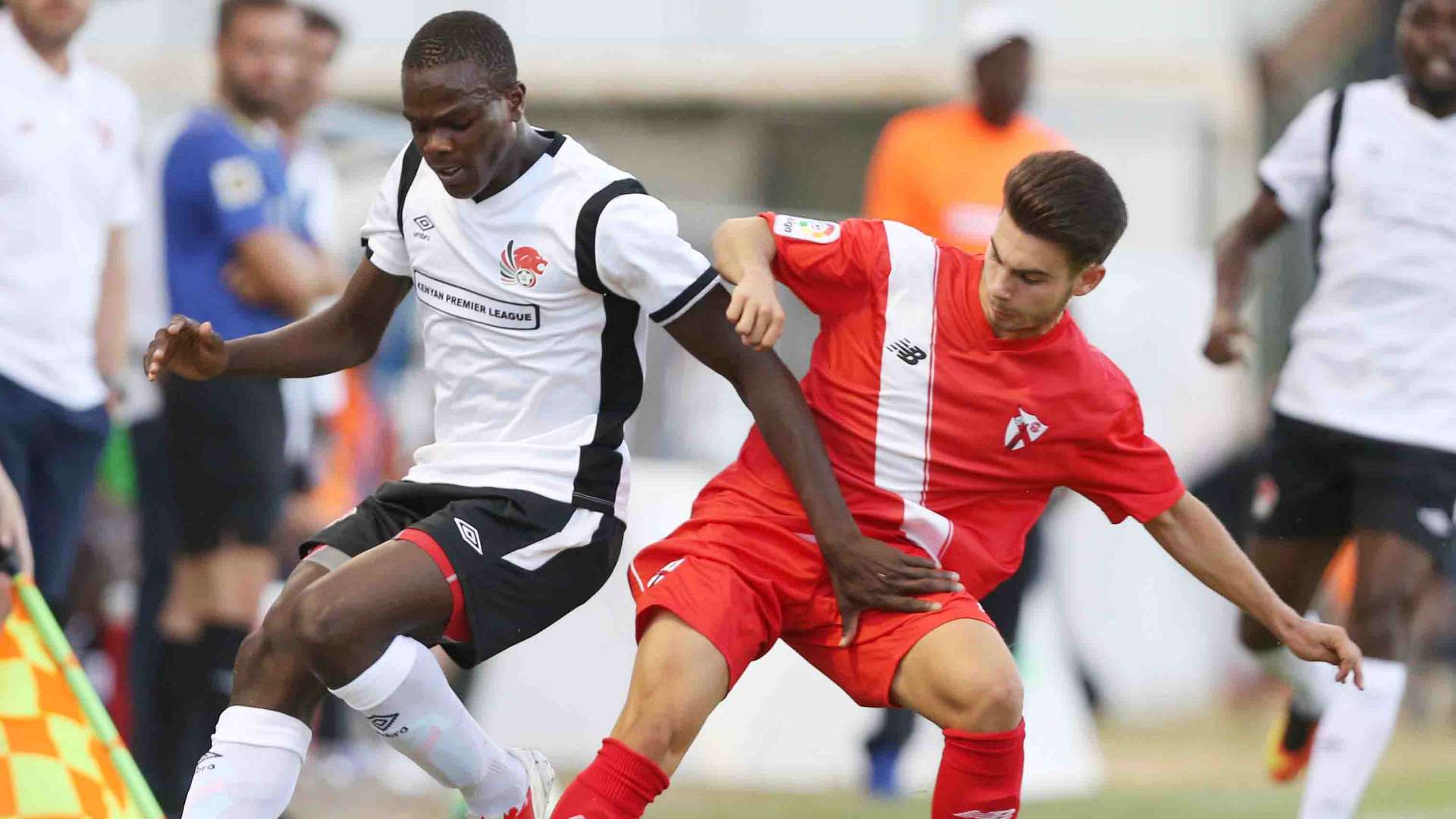 Vincent Oburu (L) tackled by Jose Alonso