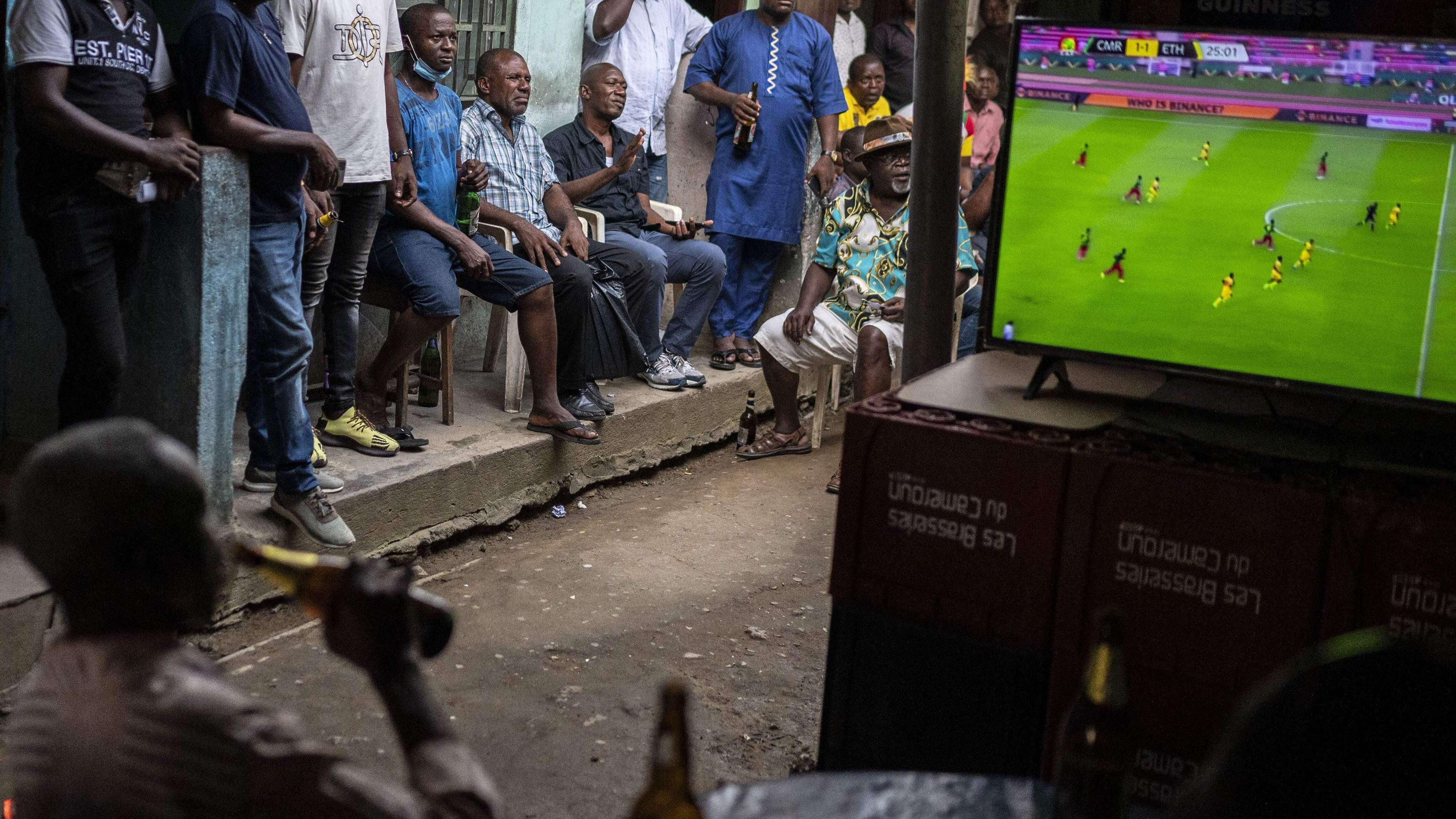 A football fan watching football on TV