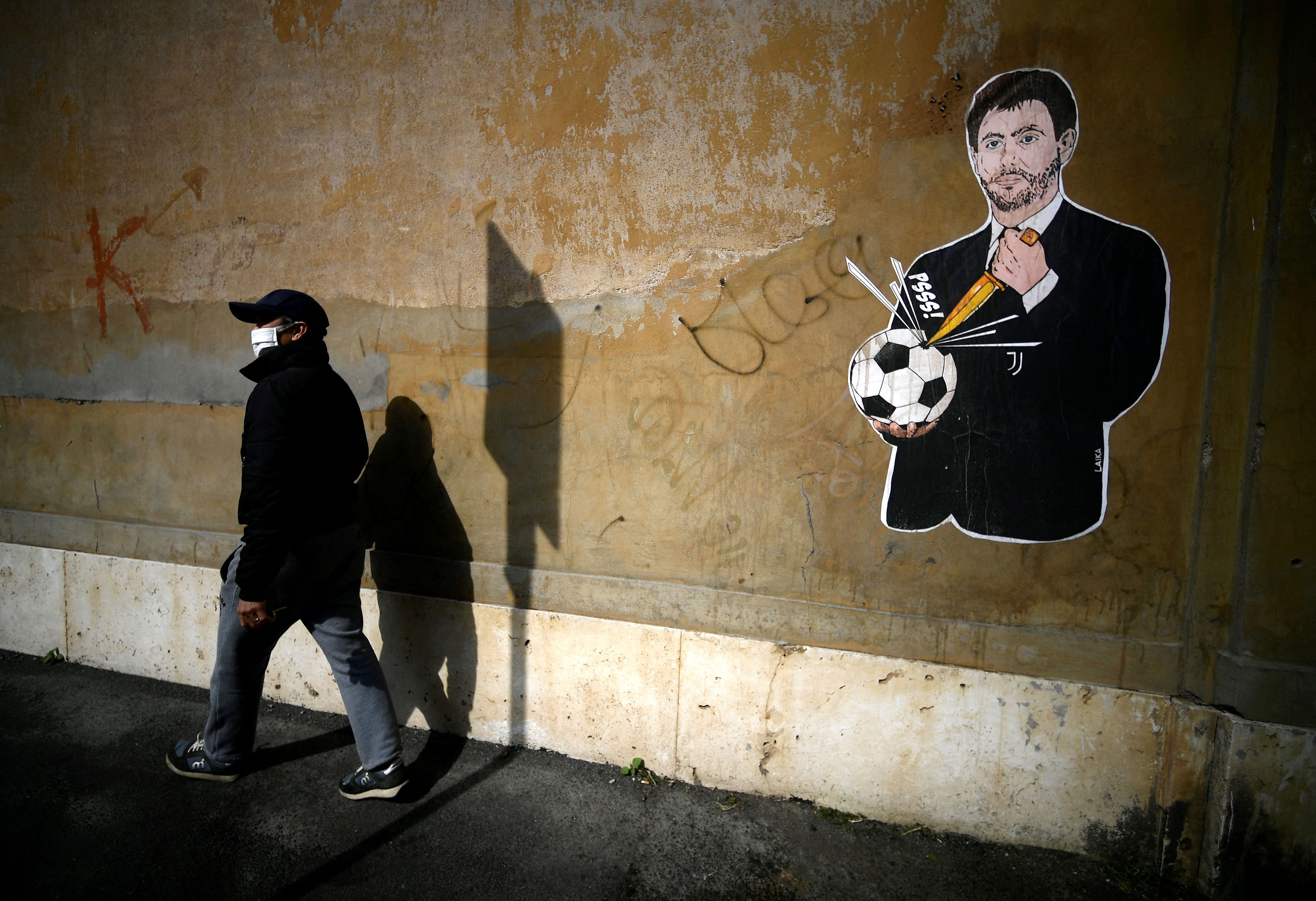 Juventus President Andrea Agnelli puncturing a football