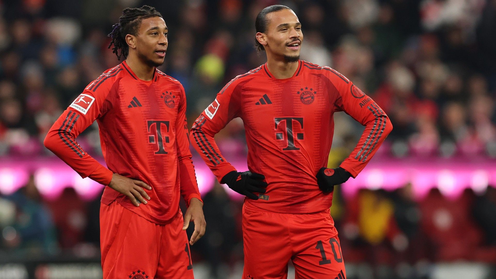 Michael Olise of FC Bayern München looks on with his team mate Leroy Sane (R) 