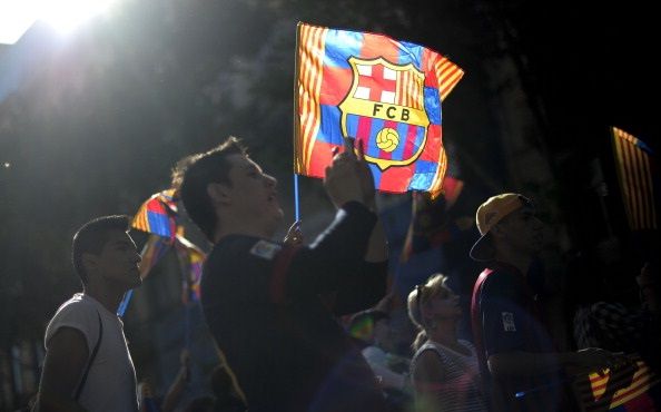 A ray of sun enlightens a flag of FC Barcelona