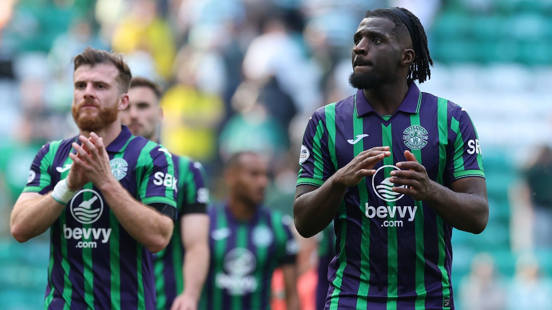 Rocky Bushri of Hibernian applauds the fans