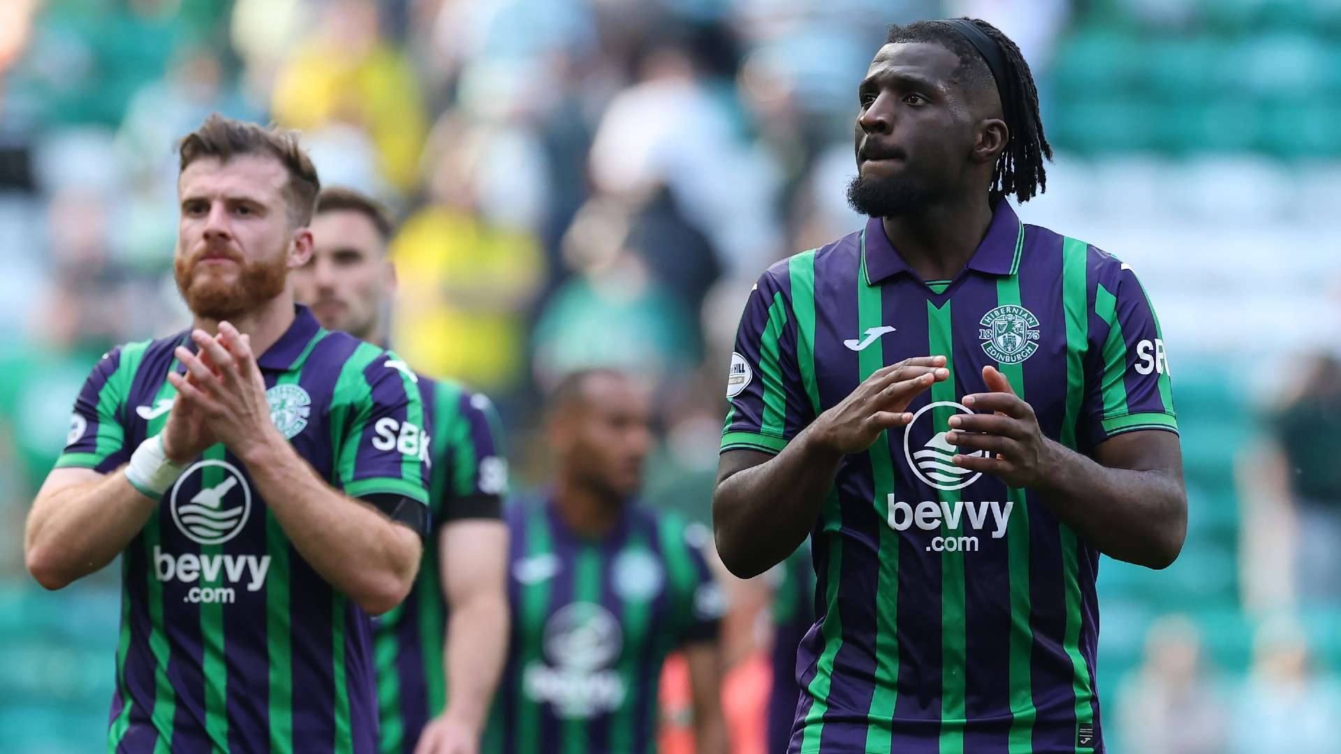 Rocky Bushri of Hibernian applauds the fans