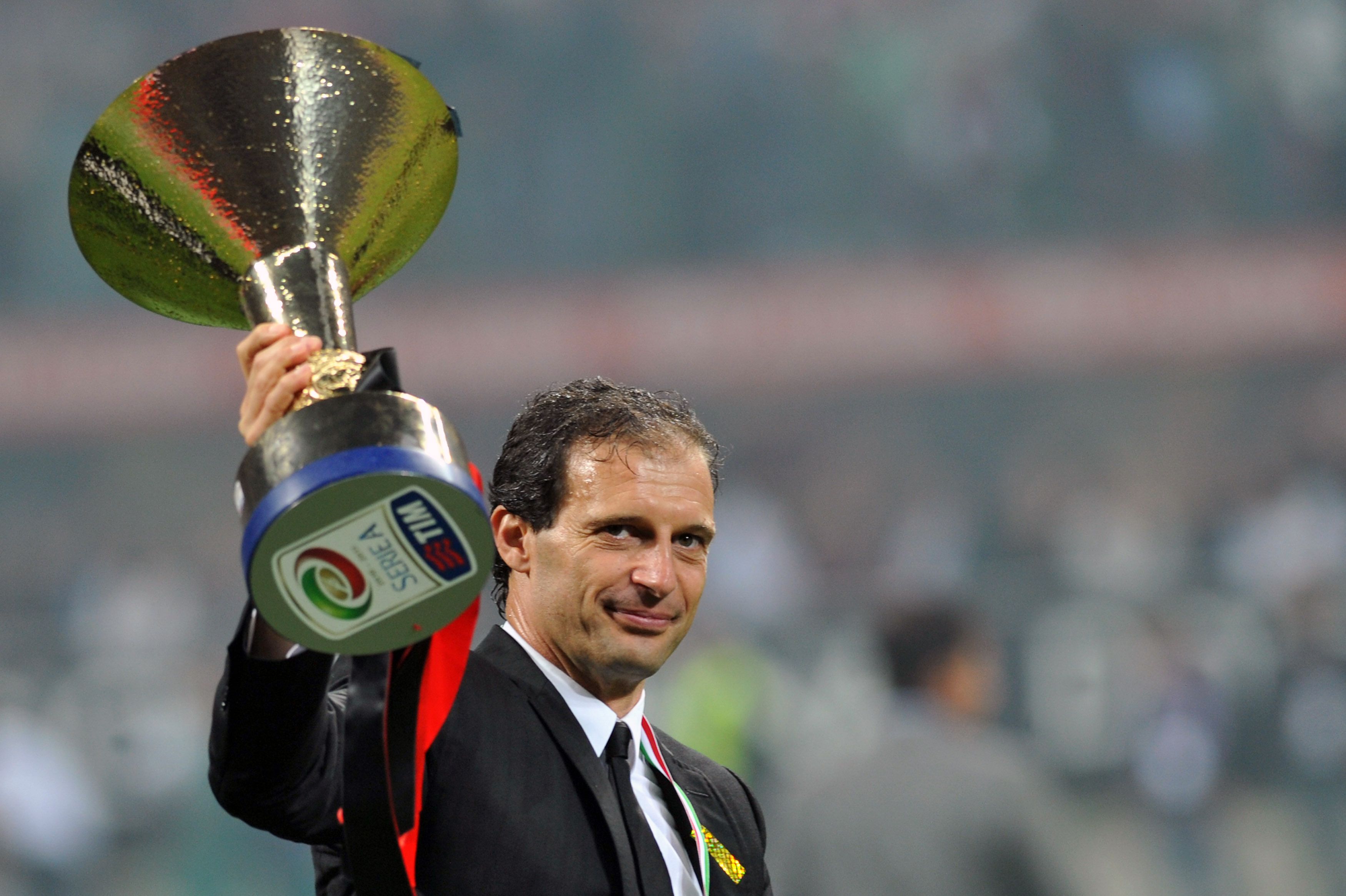 AC Milan's coach Massimiliano Allegri holds the Scudetto trophy