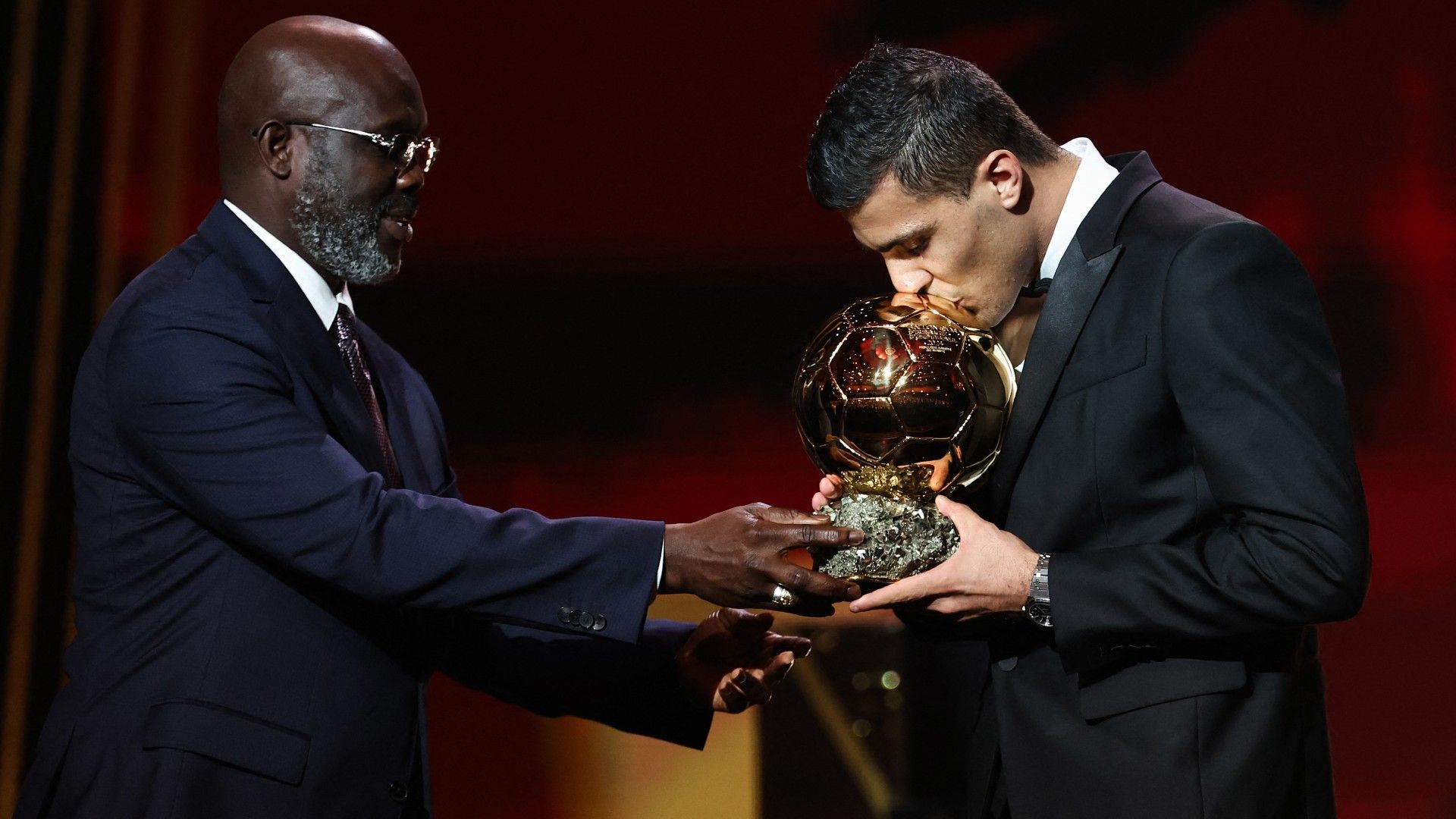 Manchester City's Spanish midfielder Rodri kisses the trophy as he receives the Ballon d'Or award 