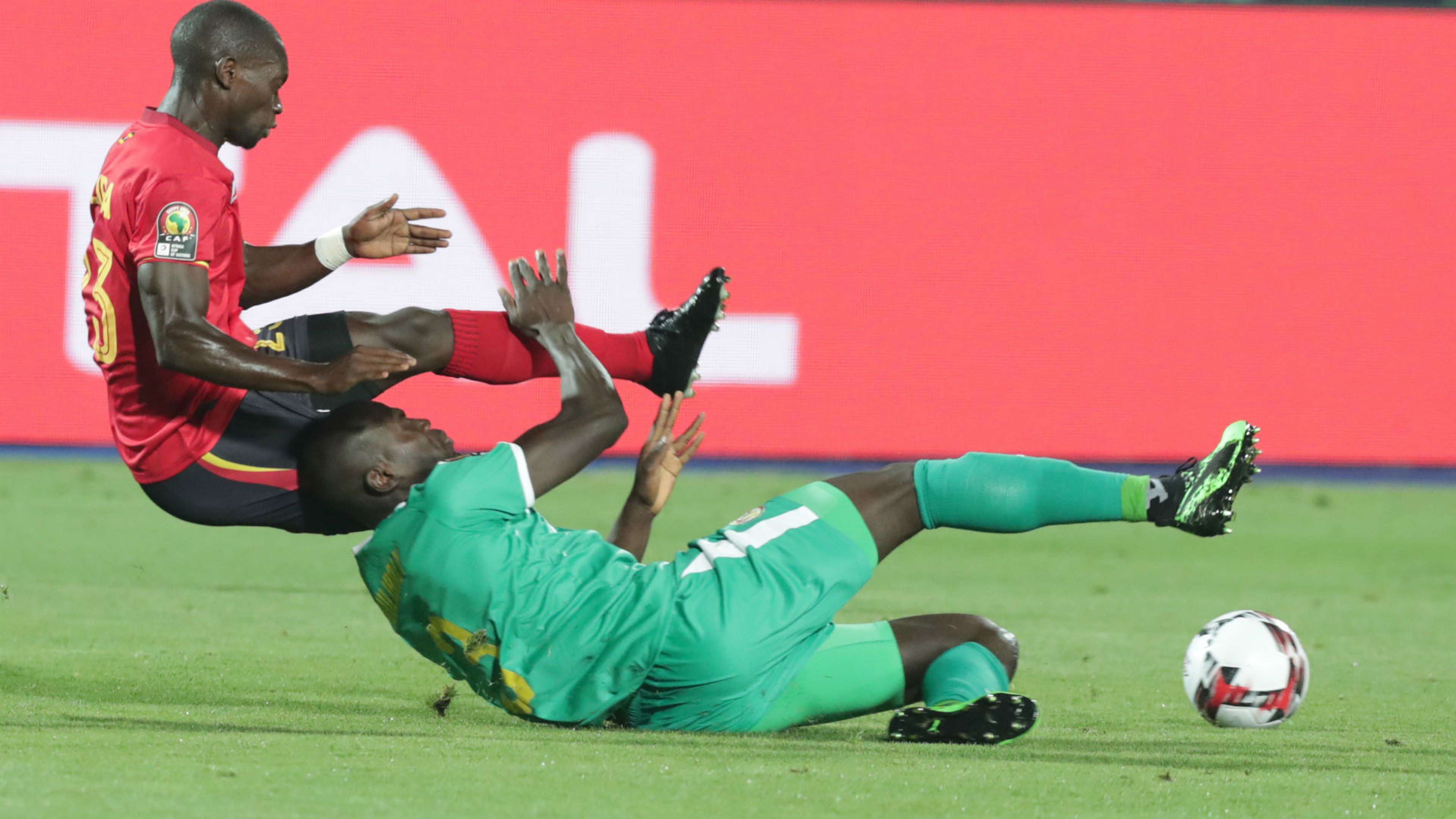 Senegal's Kalidou Koulibaly (bottom) in action Uganda's Michael Azira (L).