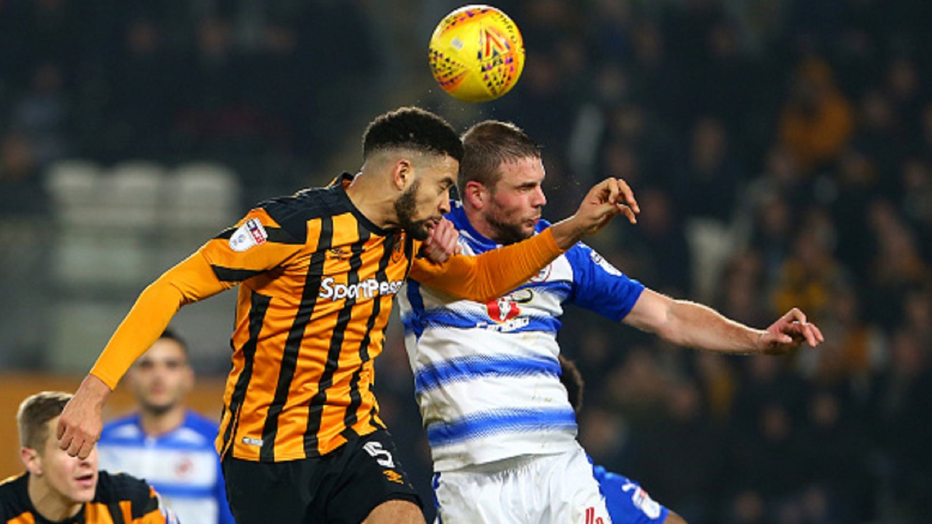 Michael Hector of Hull City wins a header as Joey van den Berg of Reading