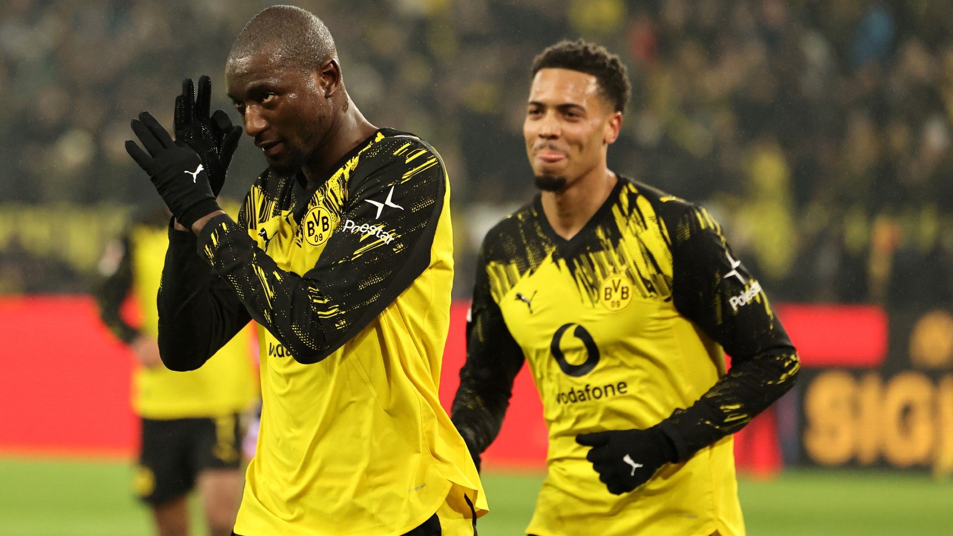 Serhou Guirassy of Borussia Dortmund celebrates scoring his team's third goal with teammate Felix Nmecha