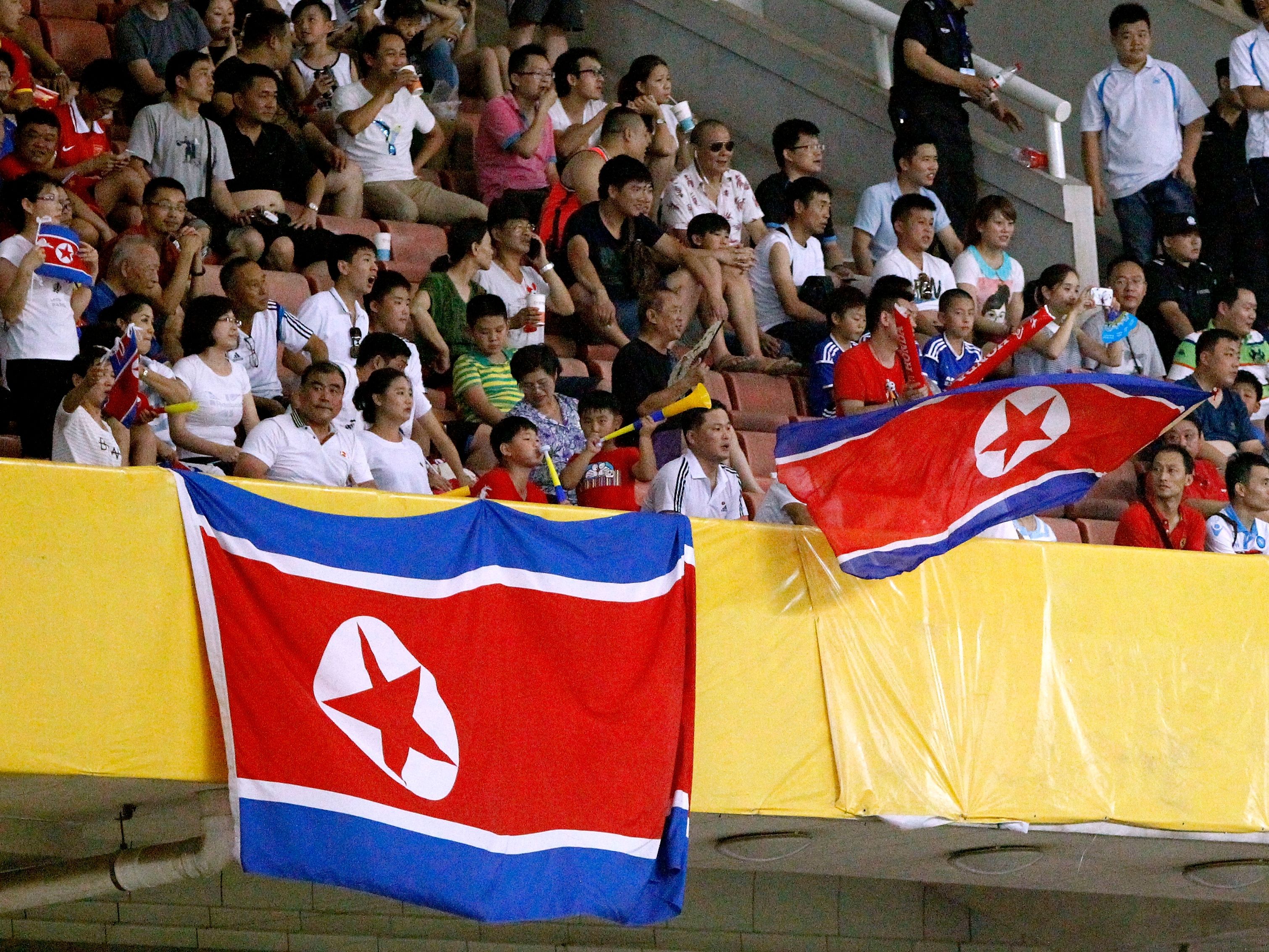Fans display national flag of DPR Korea