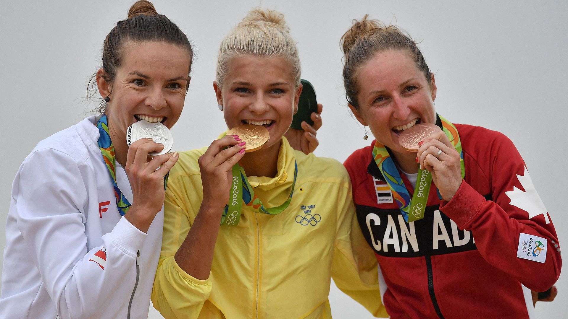 Olympians biting medals 