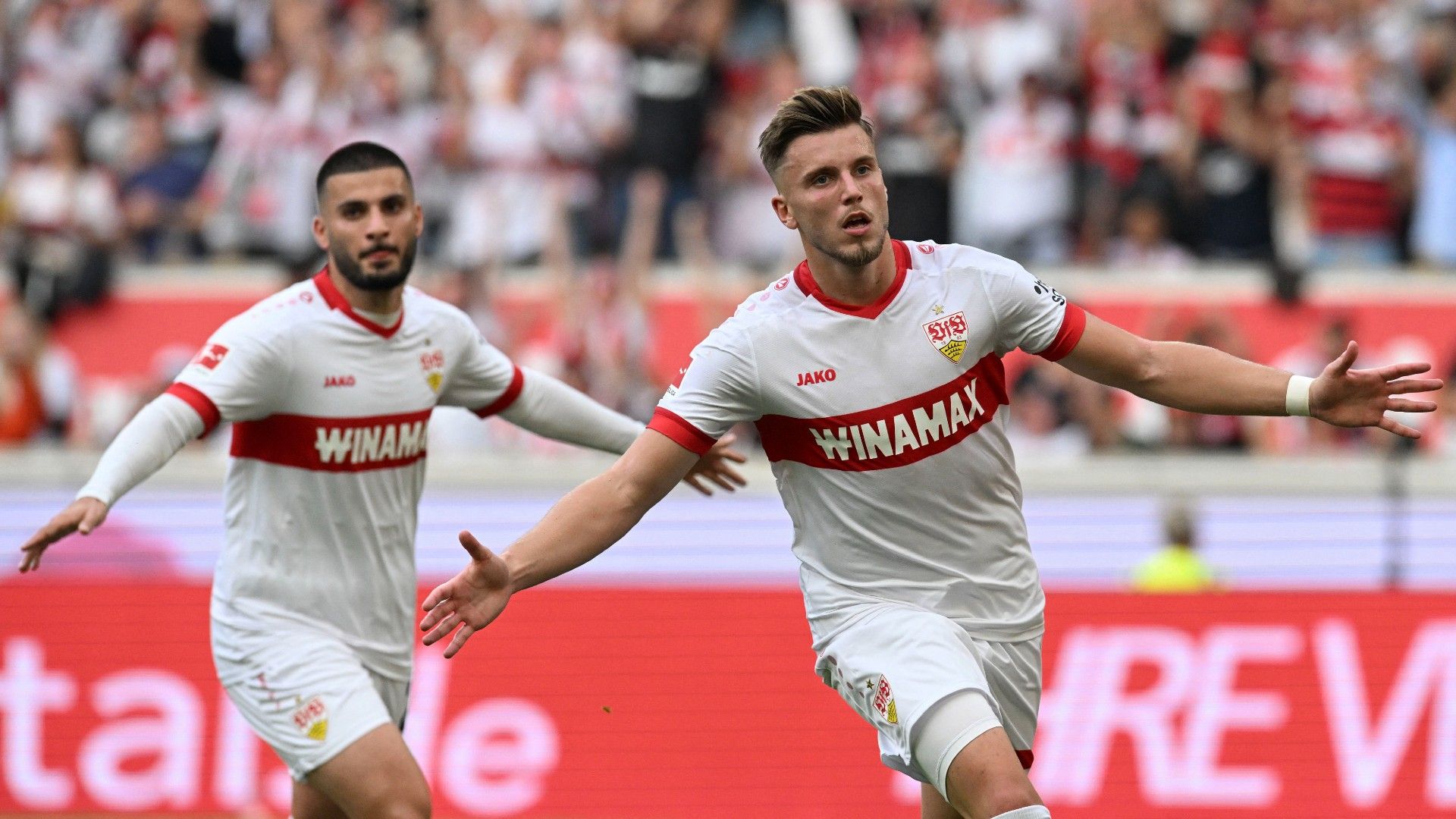 Stuttgart's Bosnian forward #09 Ermedin Demirovic (R) celebrates after he scored his team's second goal with Stuttgart's German forward #26 Deniz Undav 