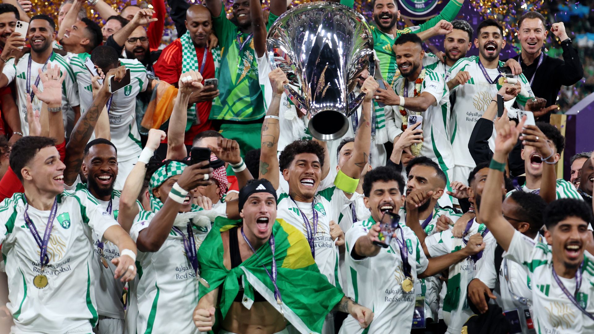 Roberto Firmino of Al-Ahli Saudi lifts The AFC Champions League Elite trophy