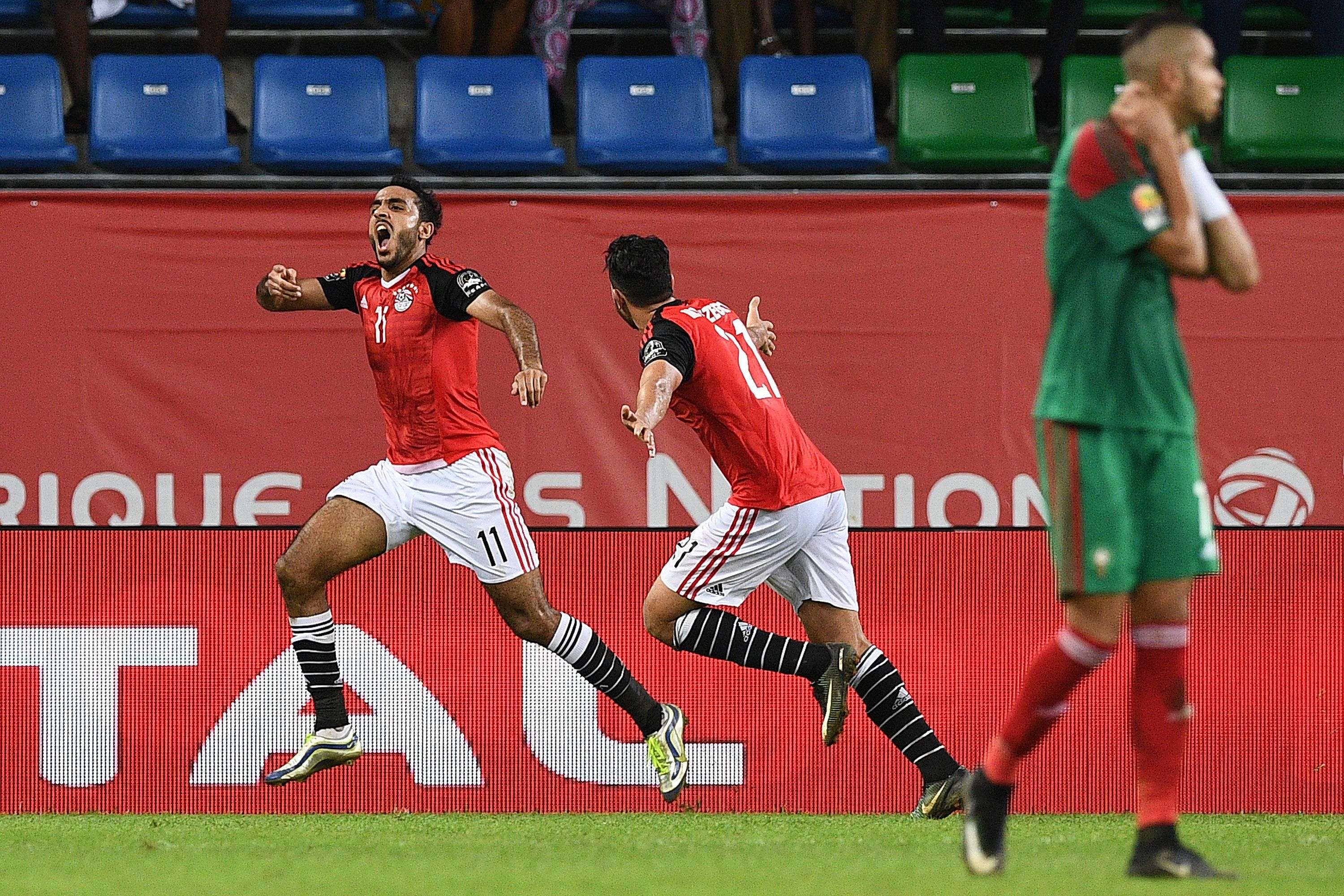Egypt's midfielder Mahmoud Abdel-Moneim (L) Kahraba celebrates with Egypt's midfielder Mahmoud Hassan