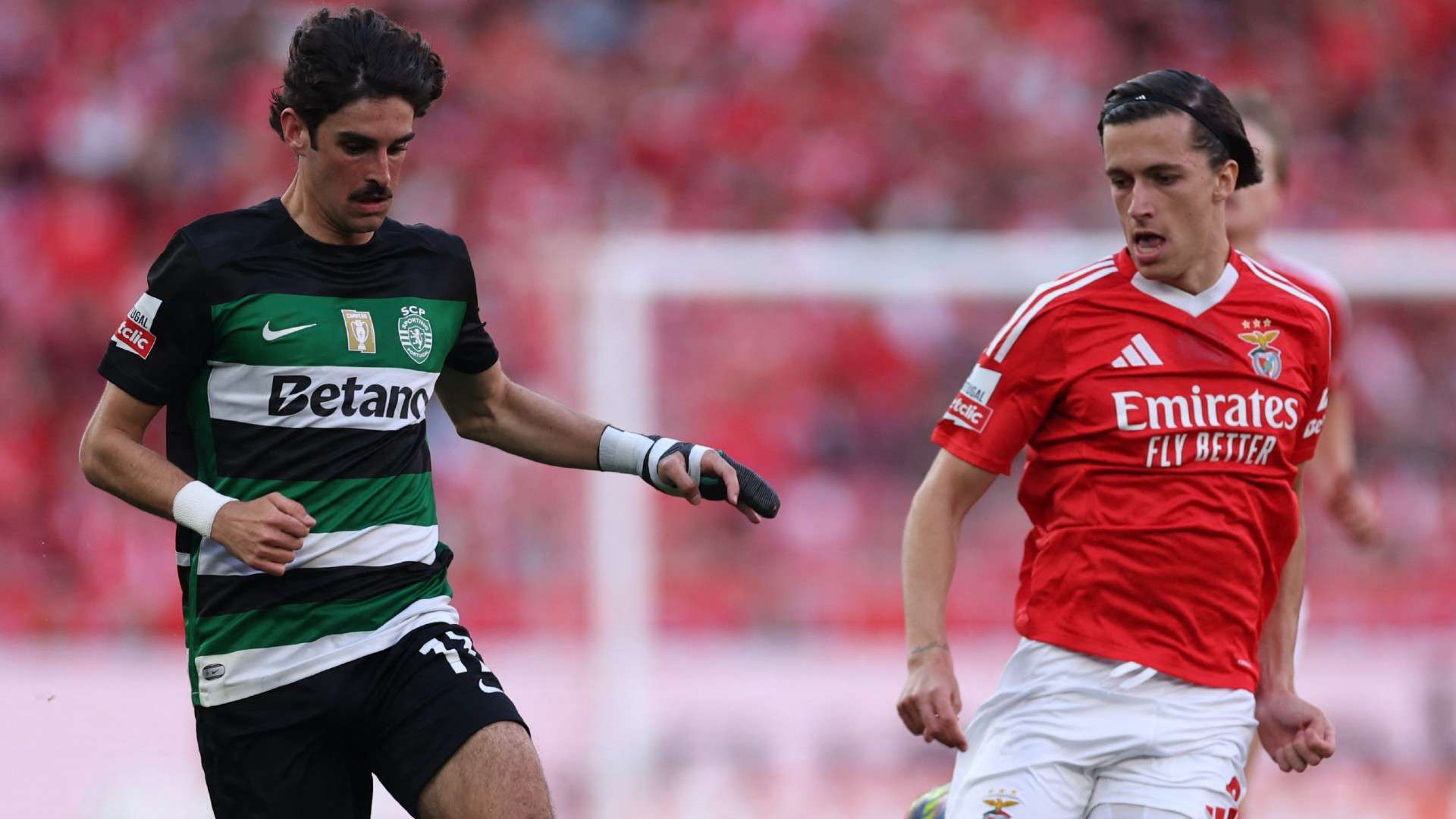 Sporting Lisbon's Portuguese forward #17 Francisco Trincao (L) runs with the ball challenged by Benfica's Spanish defender #03 Alvaro Fernandez Carreras