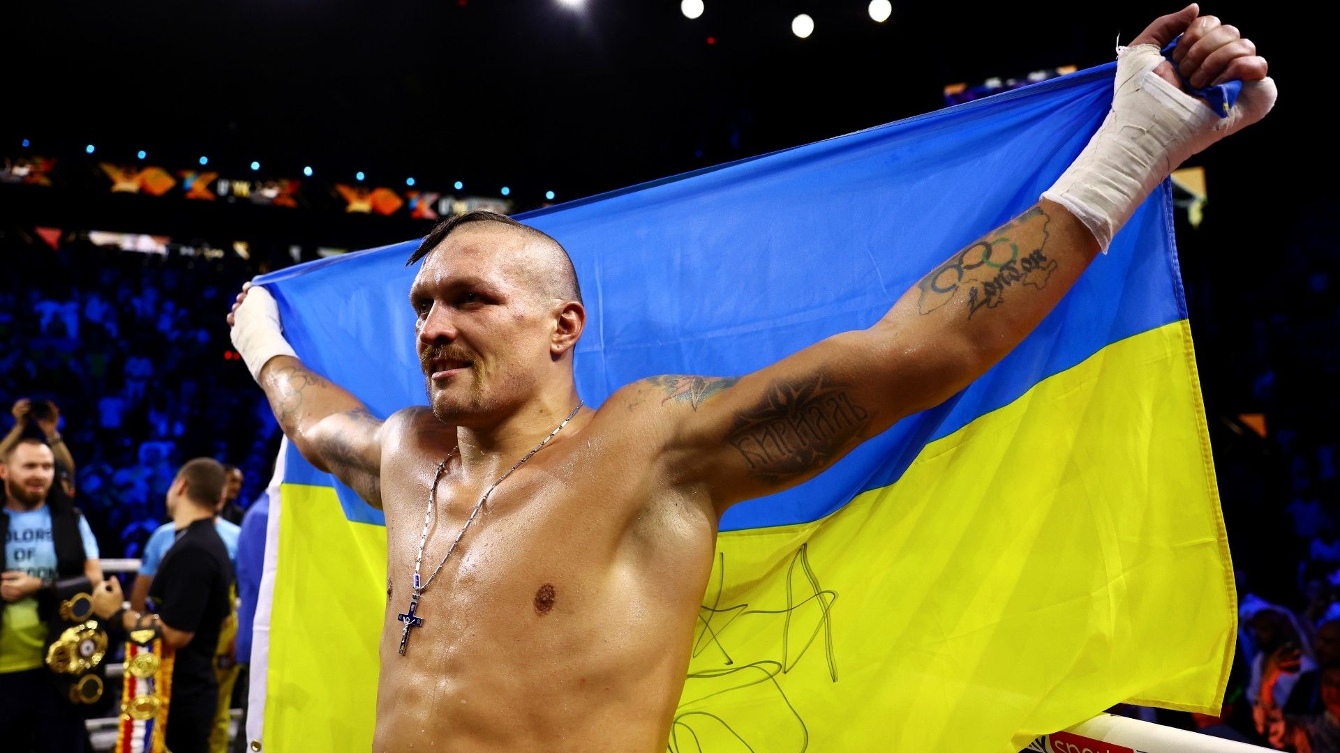 Oleksandr Usyk celebrates with a flag of Ukraine