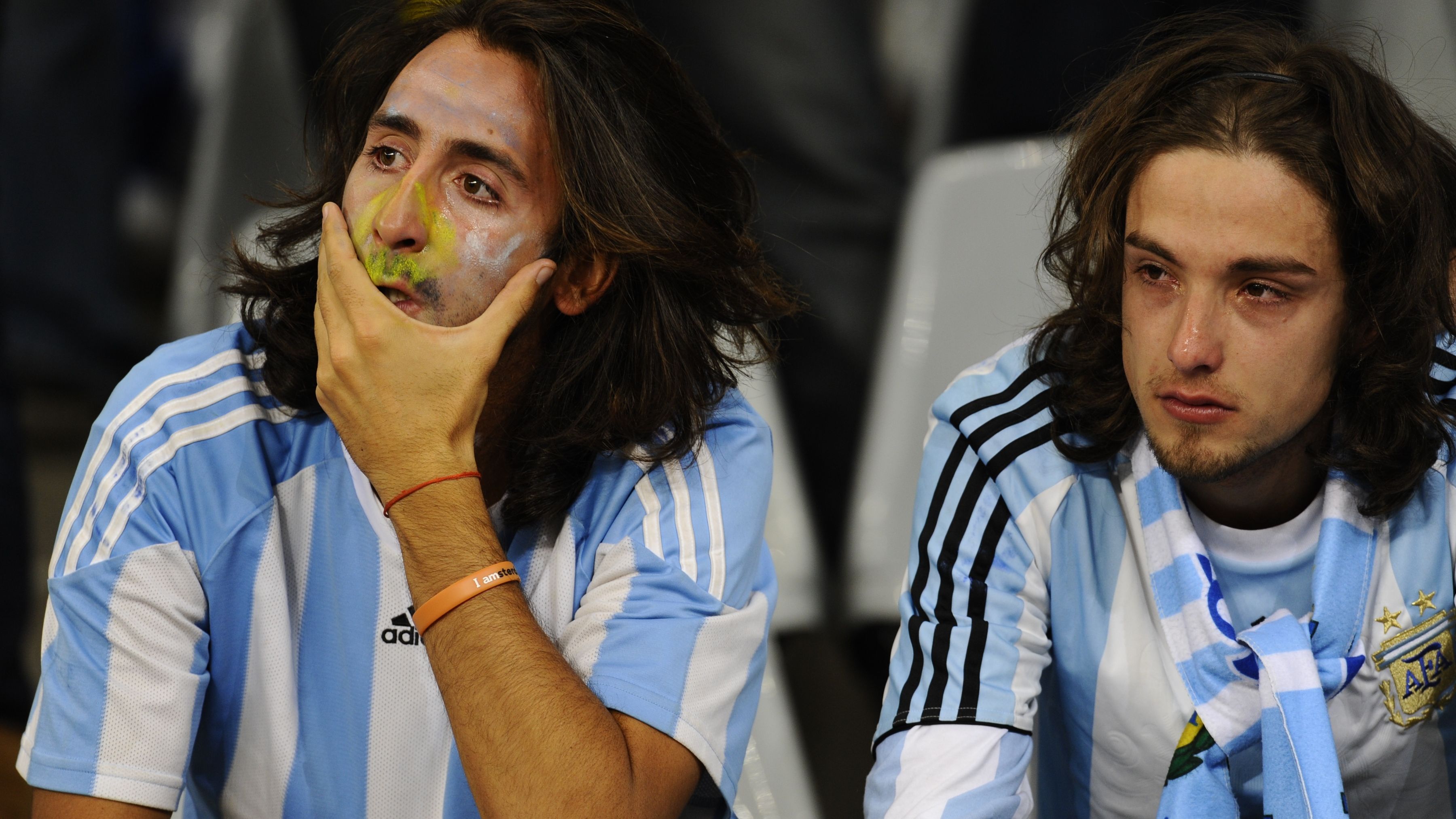 Supporters of Argentina cry after their team's loss at the end of the 2010 World Cup