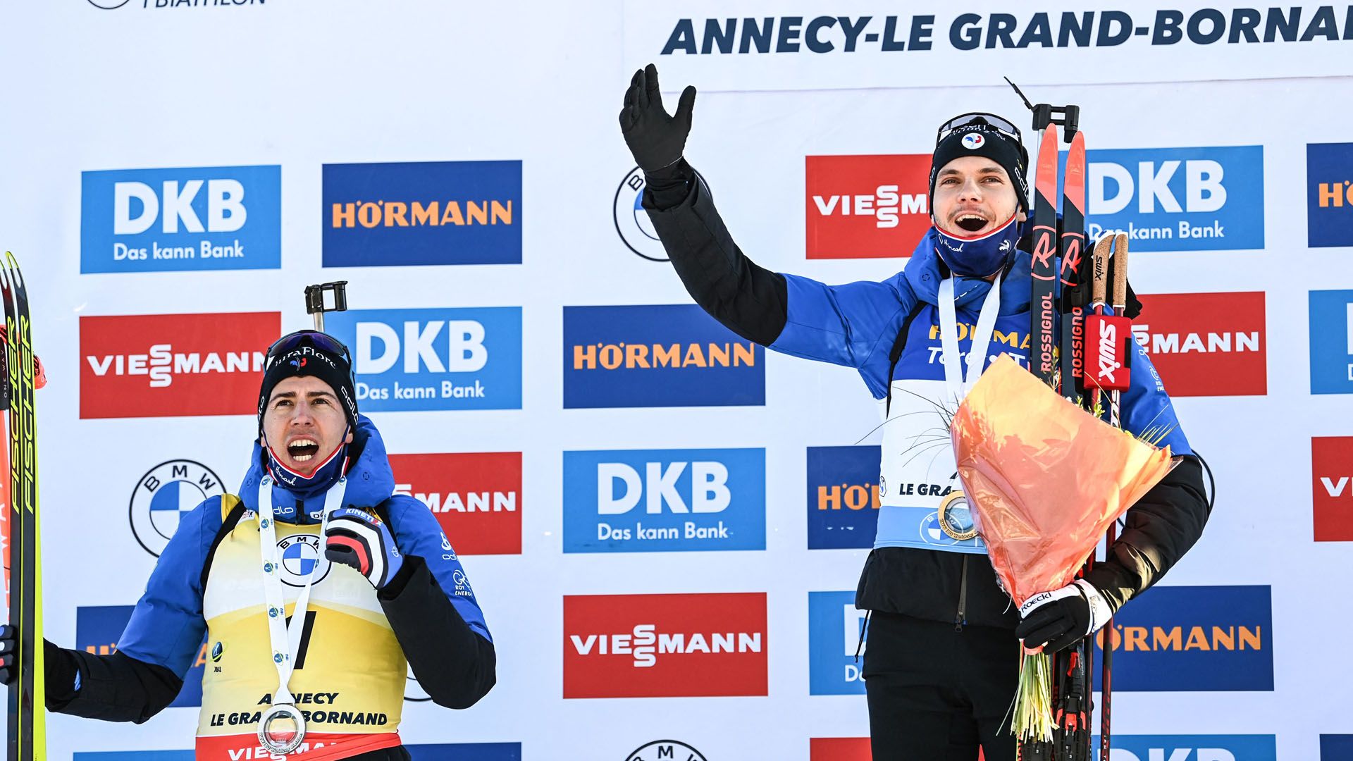 Second placed silver medallist Frenchs Quentin Fillon-Maillet (L), celebrates with Gold medallist French biathlete Emilien Jacquelin on the podium