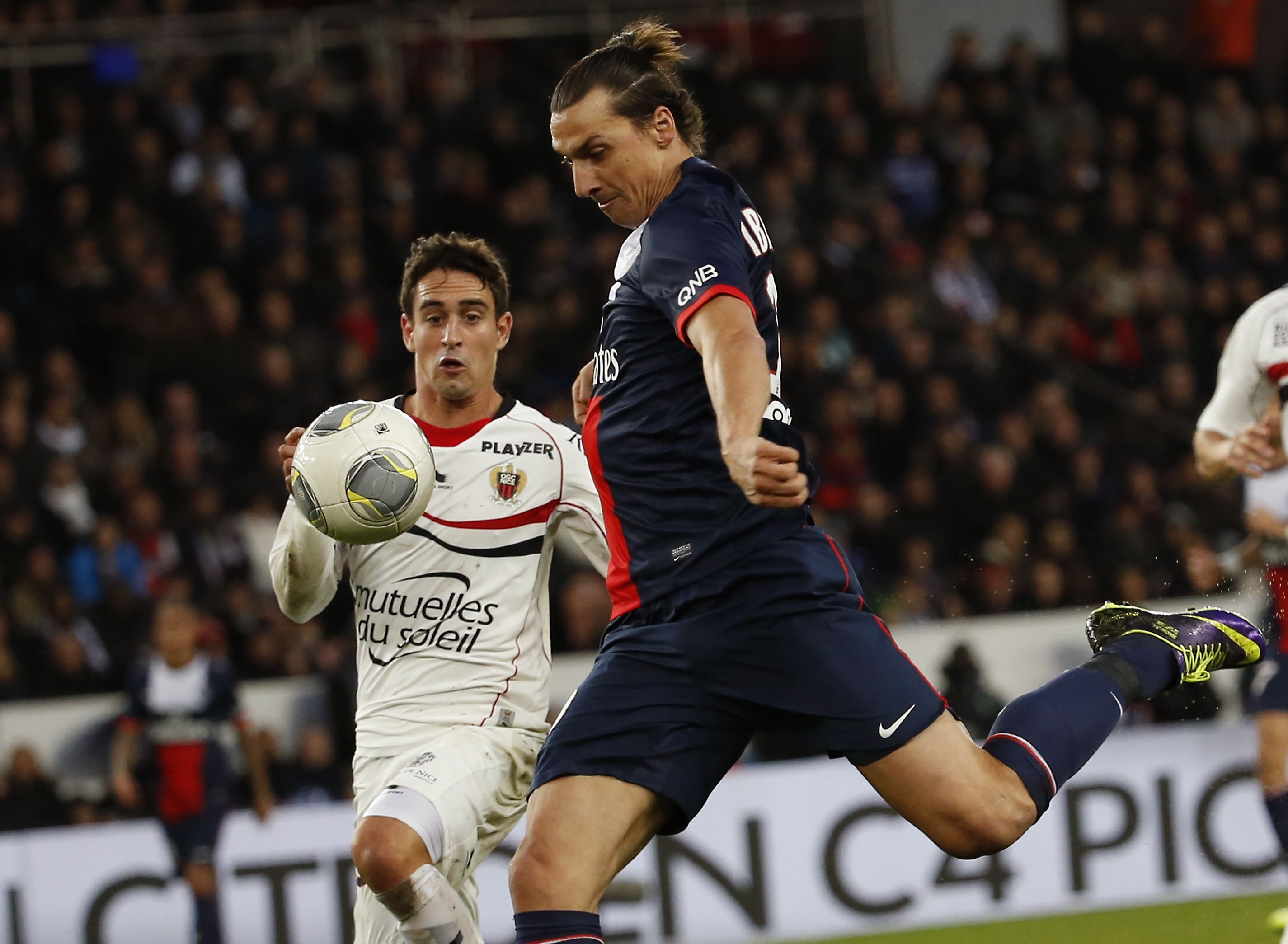 PSG's Zlatan Ibrahimovic competes for the ball with Nice's Gregoire Puel