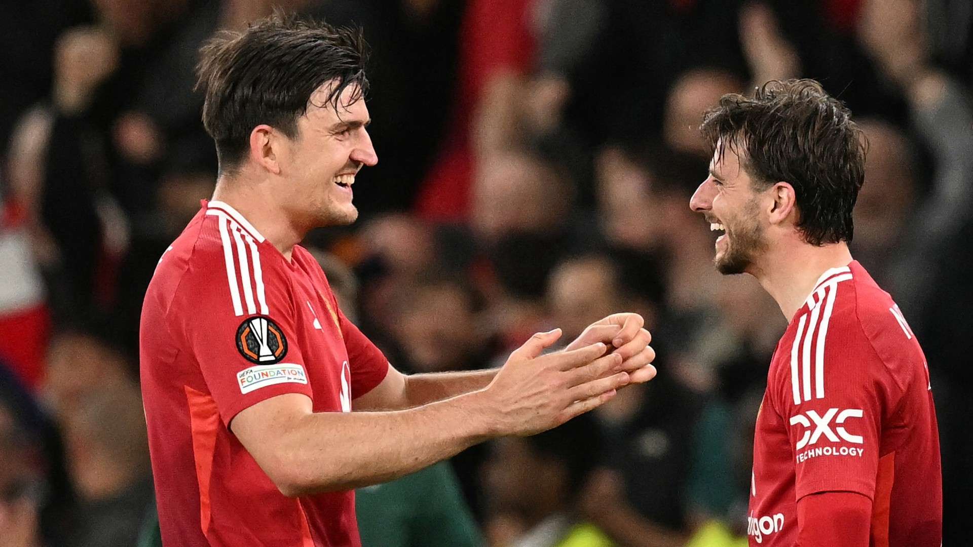 Manchester United's English midfielder #07 Mason Mount (R) celebrates Manchester United's English defender #05 Harry Maguire (L)