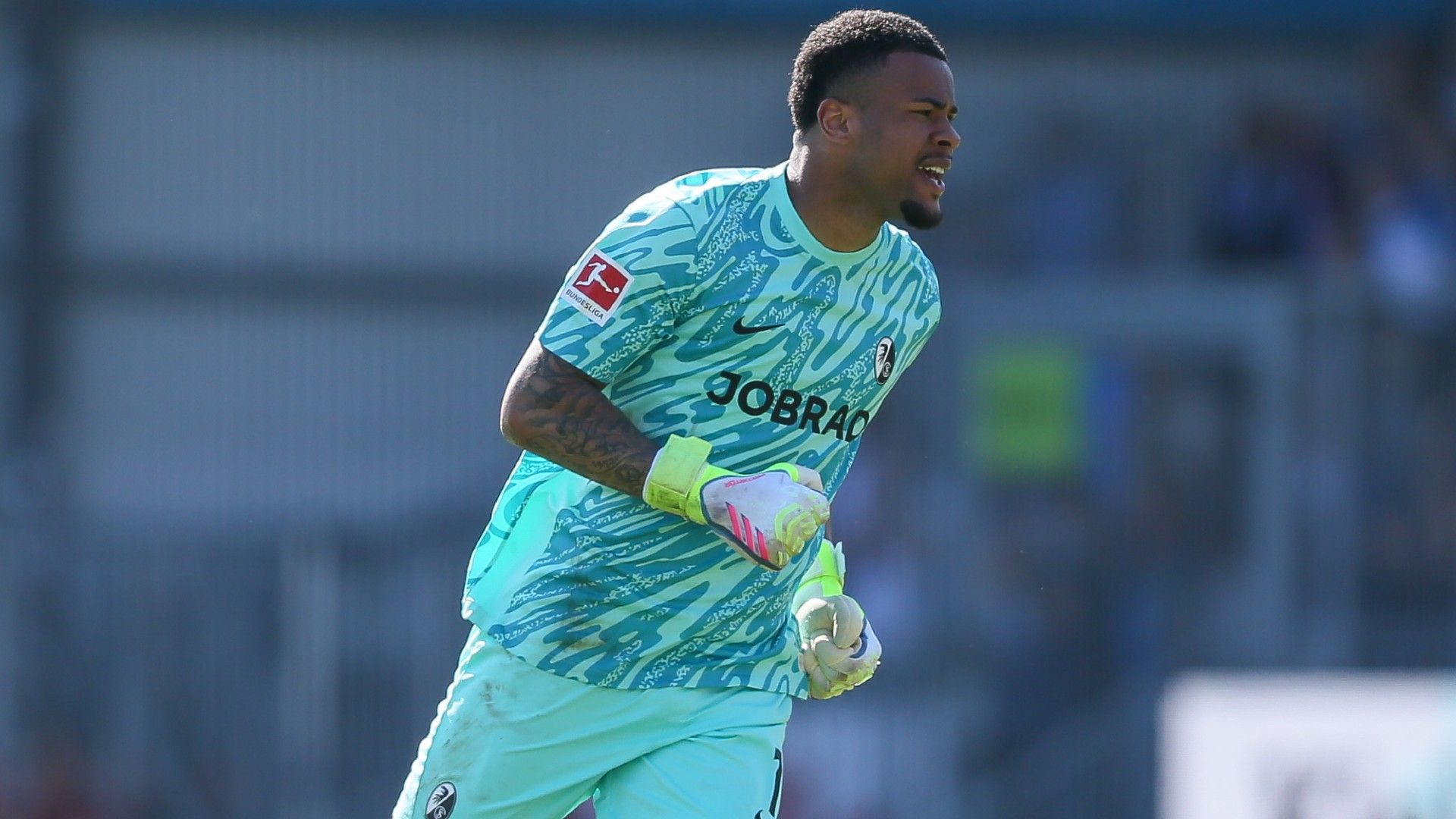 goalkeeper Noah Atubolu of Freiburg celebrate