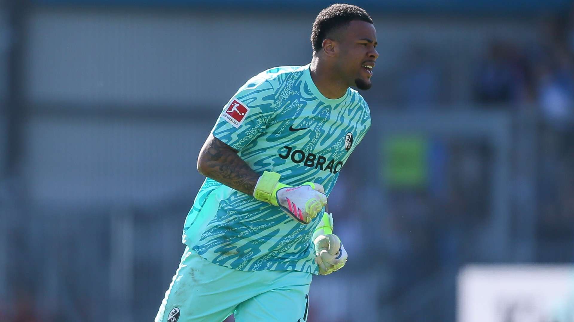 goalkeeper Noah Atubolu of Freiburg celebrate