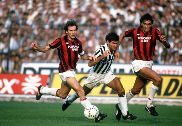 Juventus striker Massimo Briaschi, centre, races for the ball with AC Milan's Franco Baresi, left, and Dario Bonetti