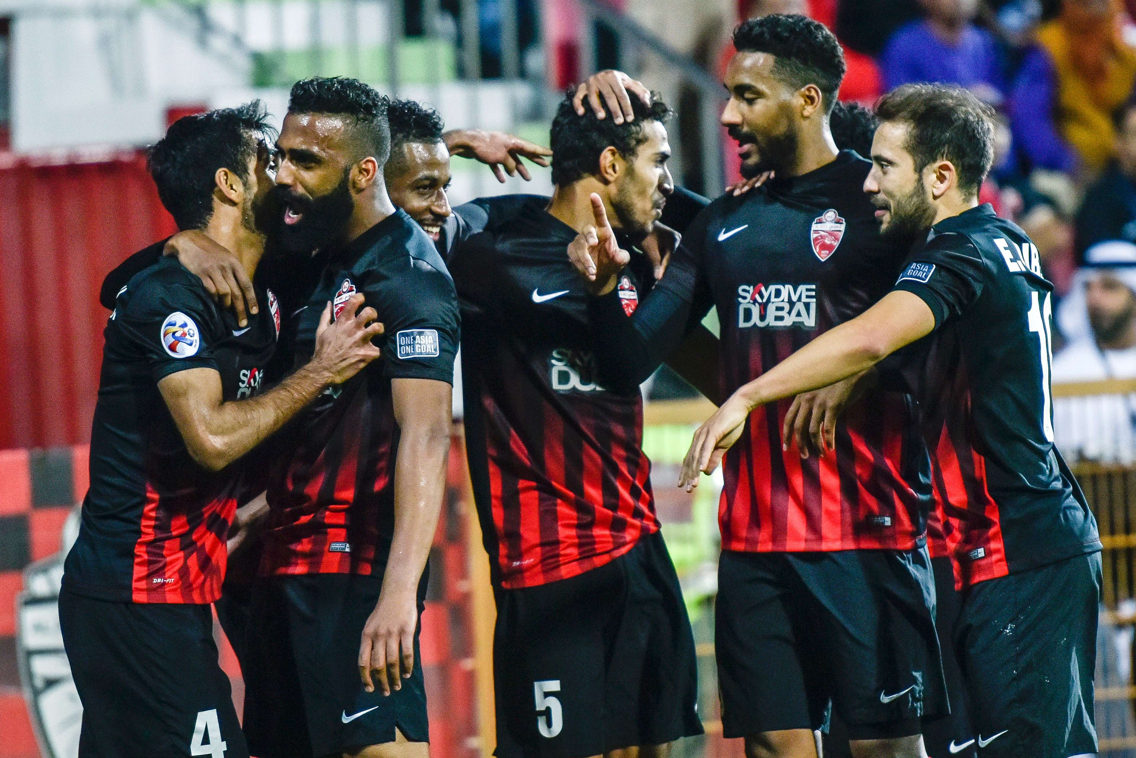 Al-Ahli players celebrate their goal during the AFC Champions League qualifying football match between UAE's Al-Ahli and Iran's Esteghlal FC