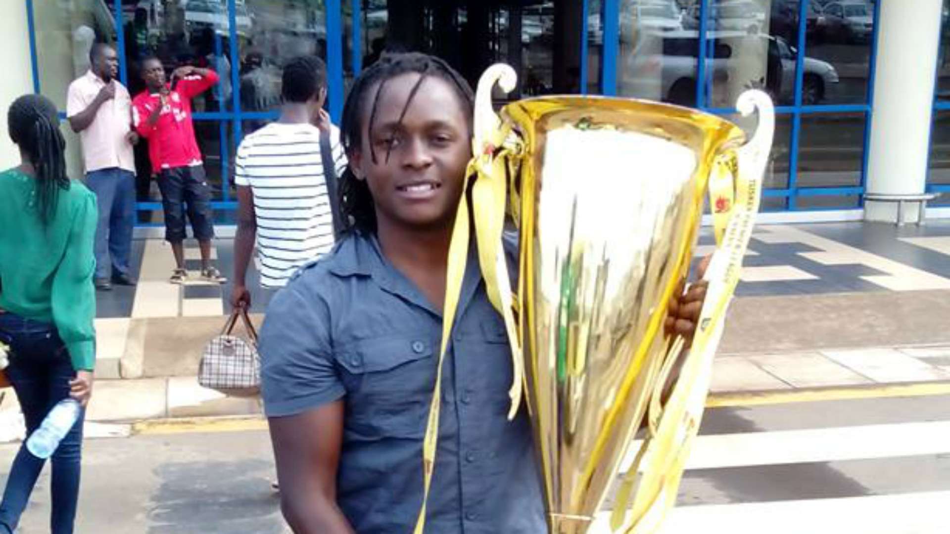 Gor Mahia midfielder Innocent Mutiso with KPL trophy.