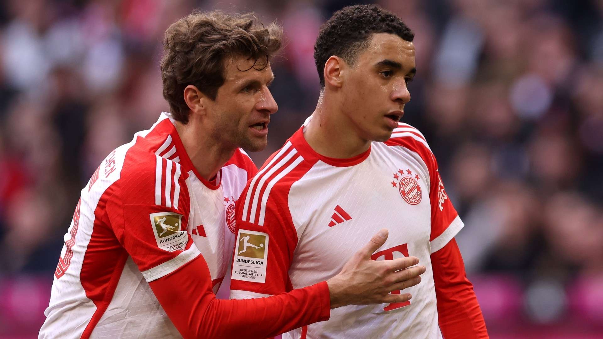 Thomas Müller of Bayern München talks to his team mate Jamal Musiala