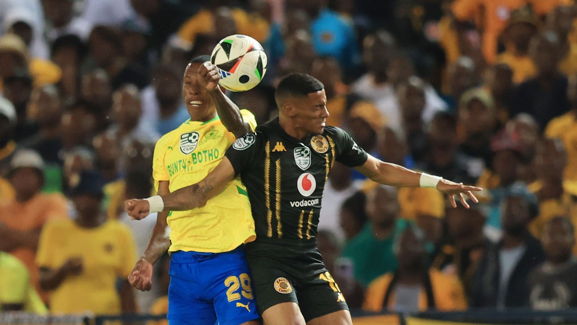 Dillan Solomons of Kaizer Chiefs tussle for the ball with Divine Lunga of Mamelodi Sundowns