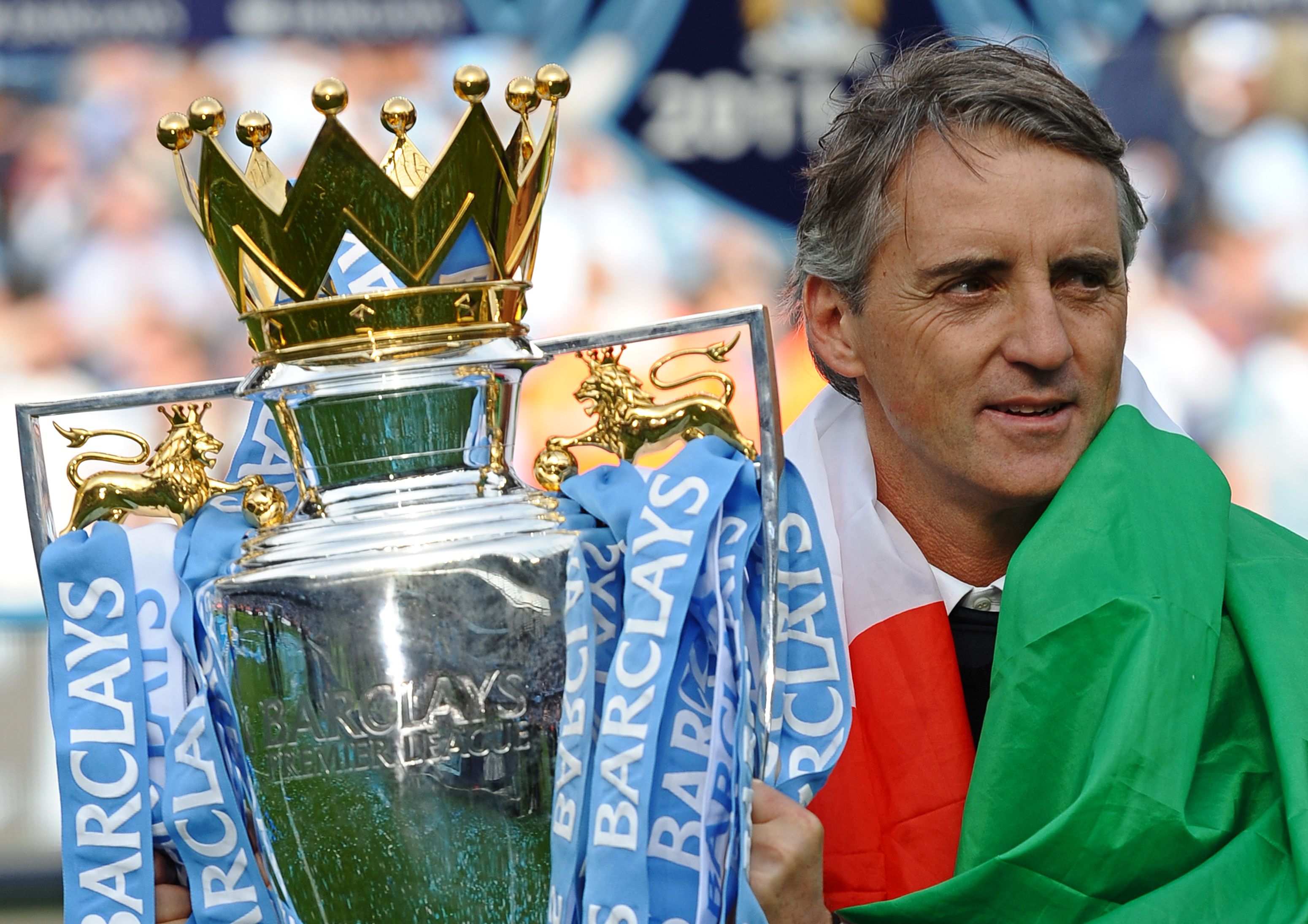 Manchester City's Italian manager Roberto Mancini celebrate with the Premier League trophy
