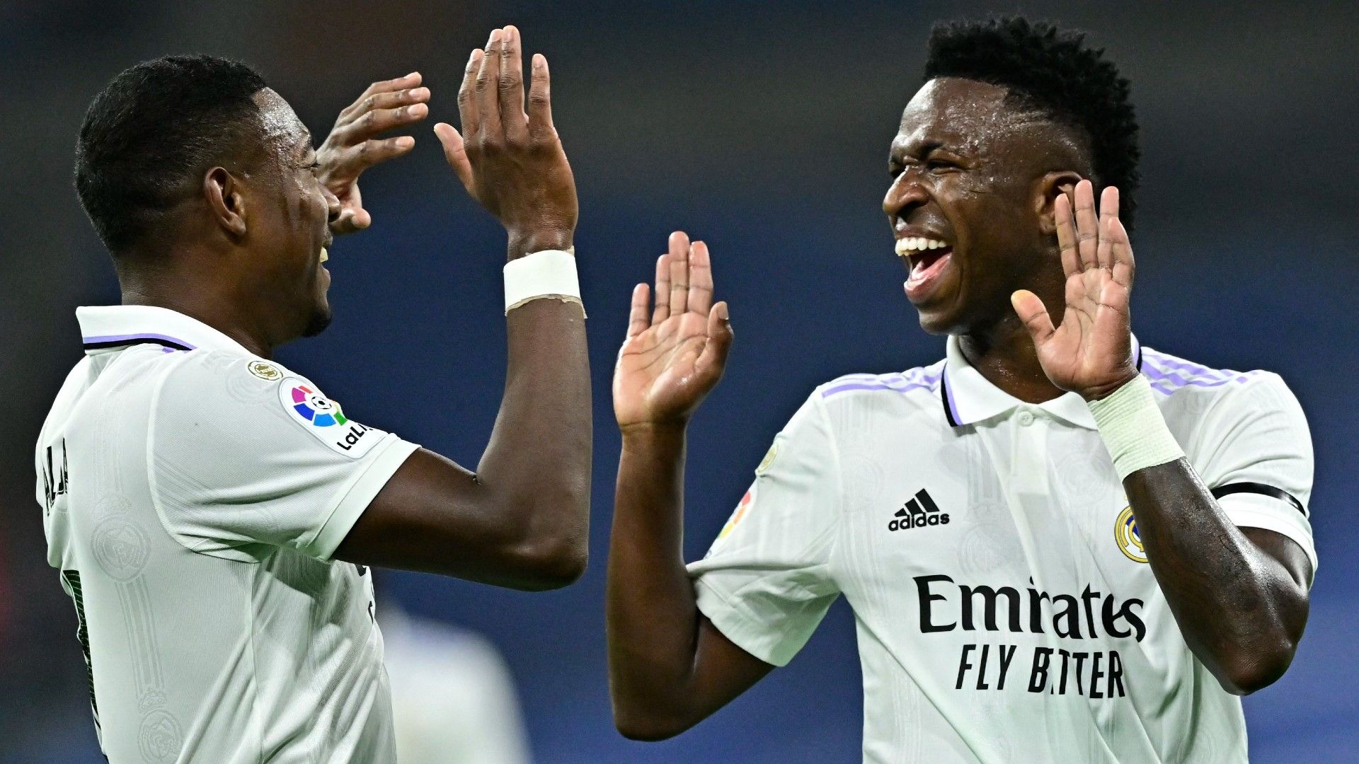 Real Madrid's Brazilian forward Vinicius Junior (R) celebrates scoring the opening goal with Real Madrid's Austrian defender David Alaba 
