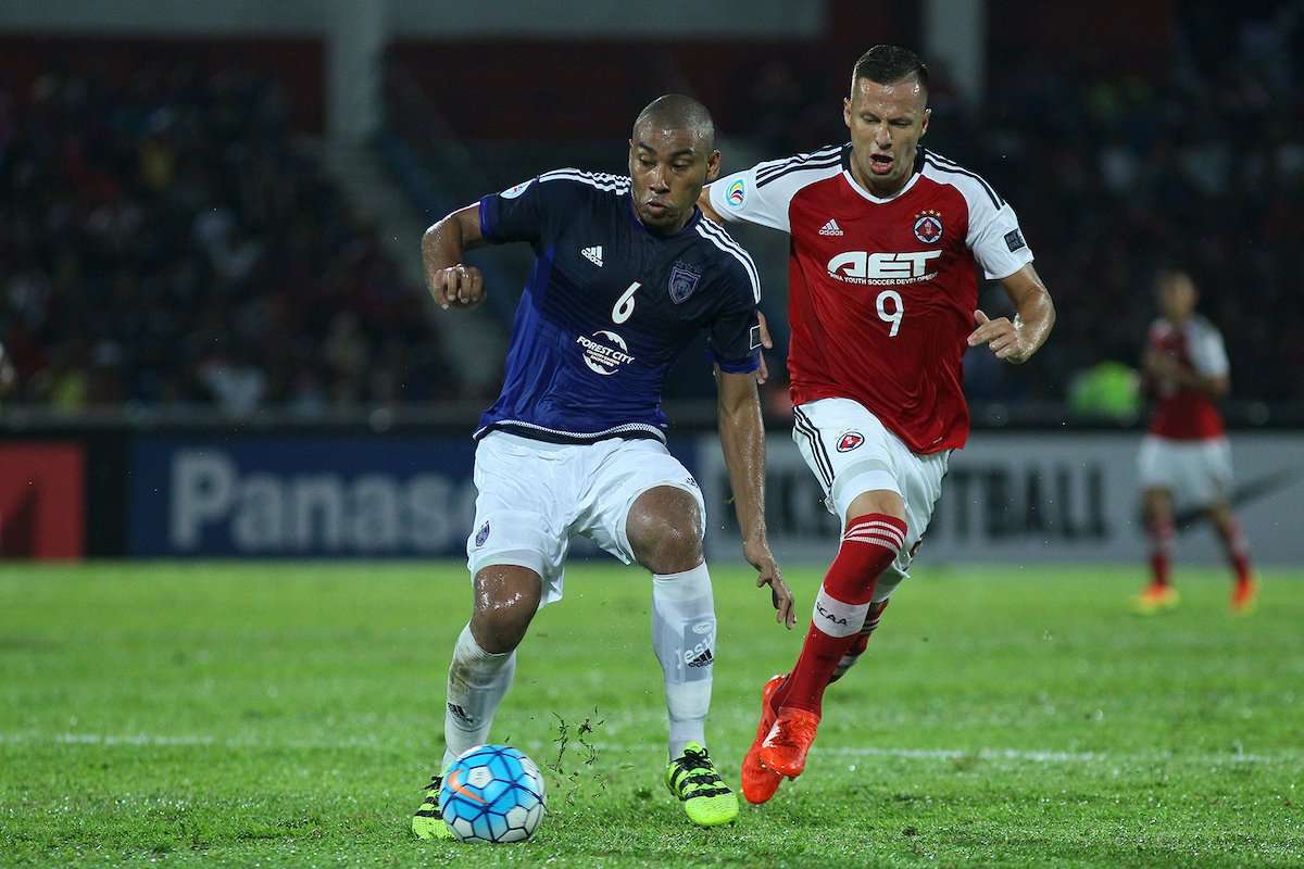 Johor Darul Ta'zim's Marcos Antonio protects the ball from South China's Nikola Komazec