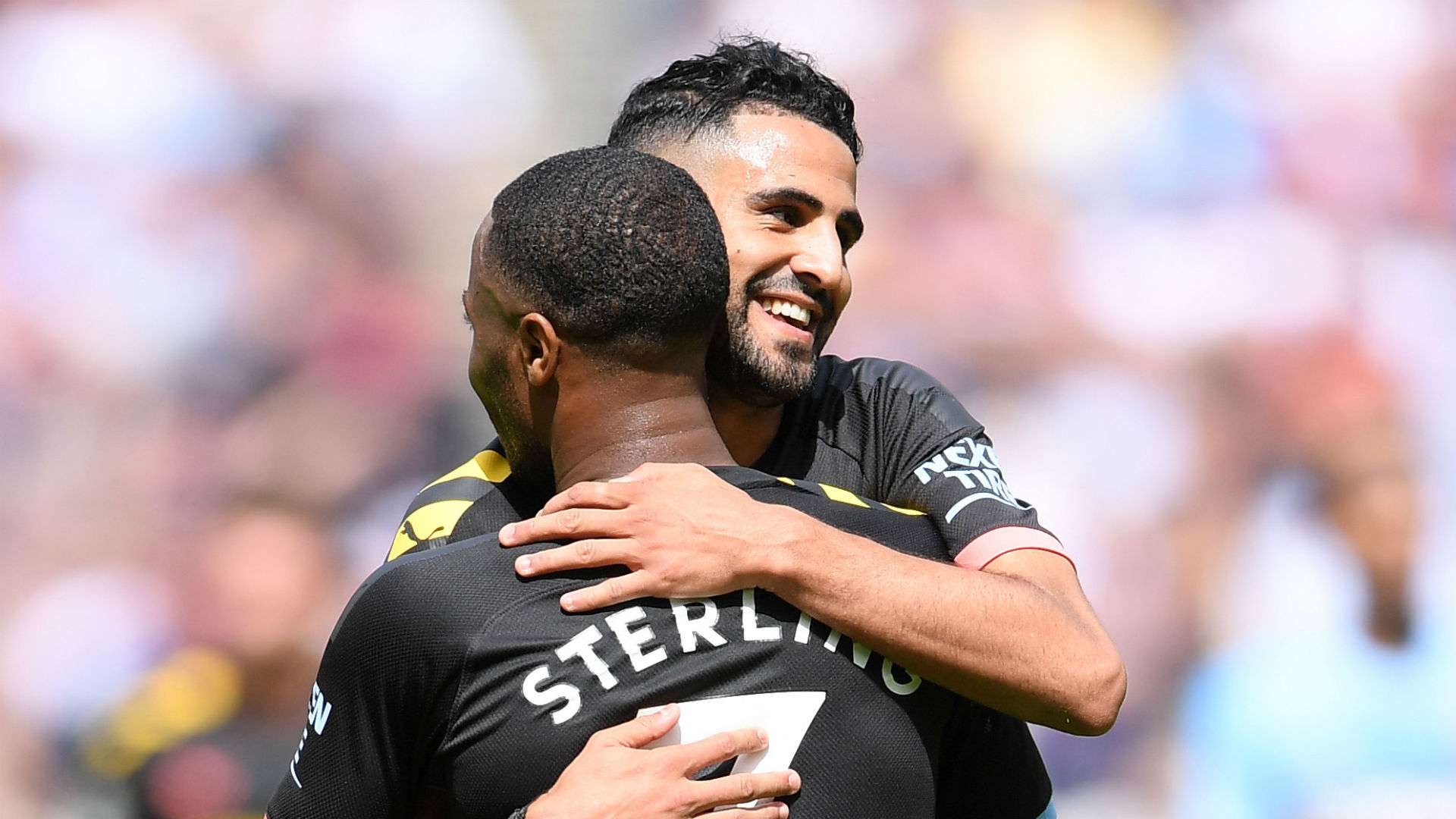 Raheem Sterling of Manchester City celebrates with teammate Riyad Mahrez 2019