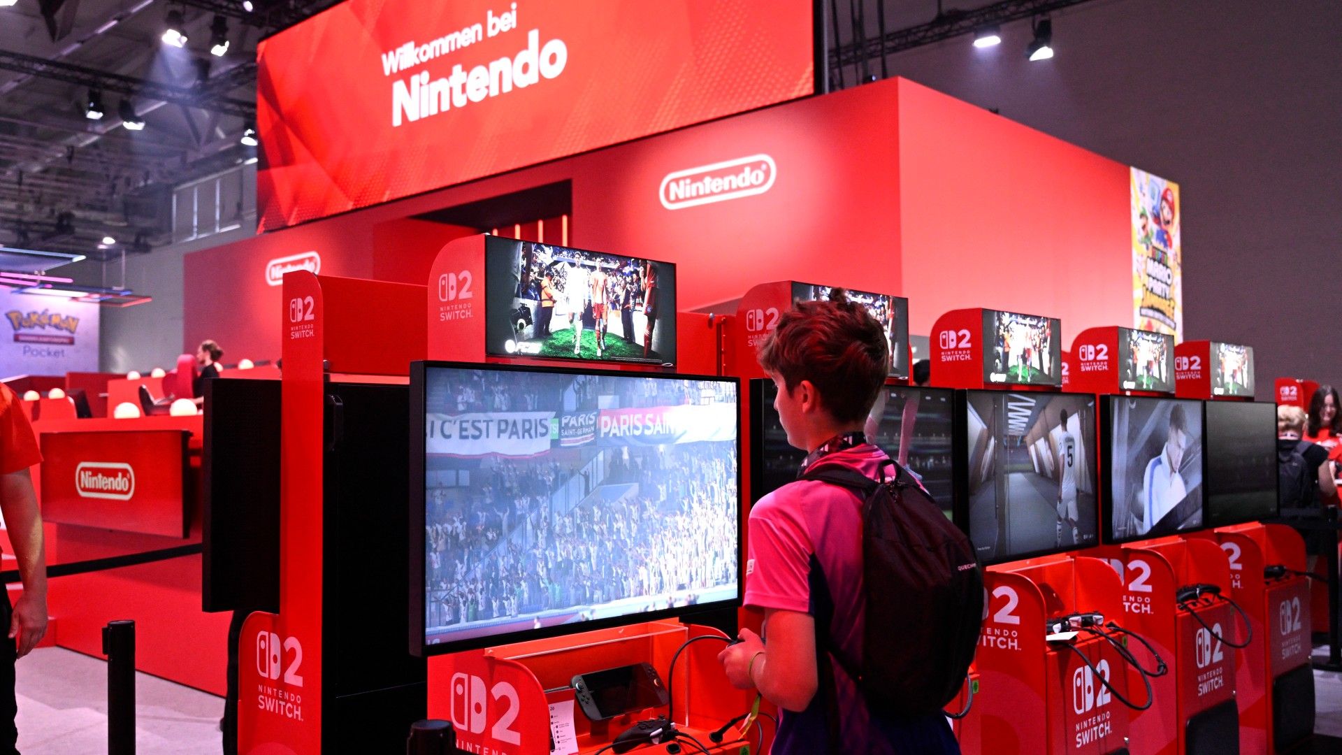 A boy plays the 'FC26' ES Sports game at the Nintendo Switch 2 booth