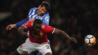 Leonardo Ulloa of Brighton & Hove Albion and Eric Bailly of Manchester United