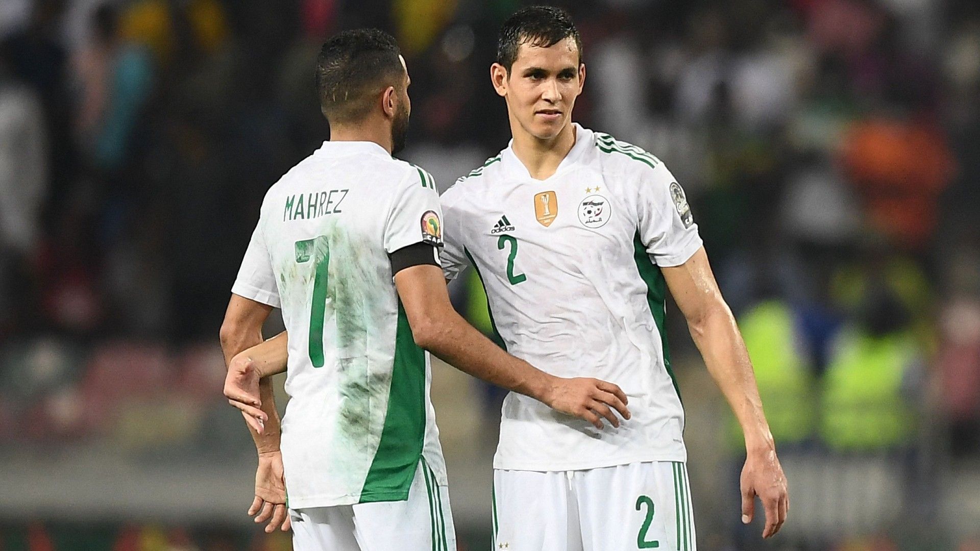 Algeria's forward Riyad Mahrez (L) and Algeria's defender Aissa Mandi (R)