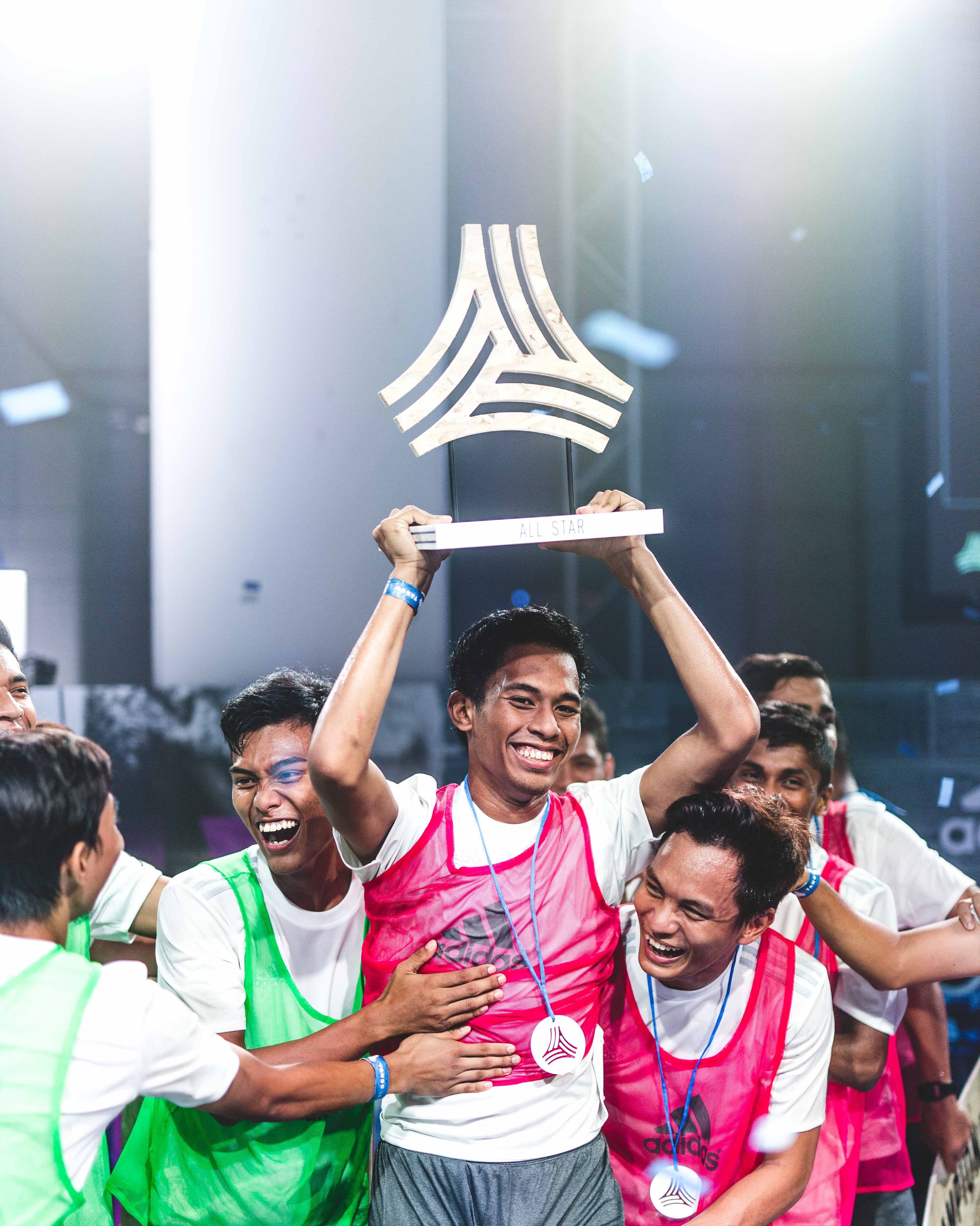 adidas Tango League Singapore MVP, Iqram Fiqri holding up his trophy among teammates
