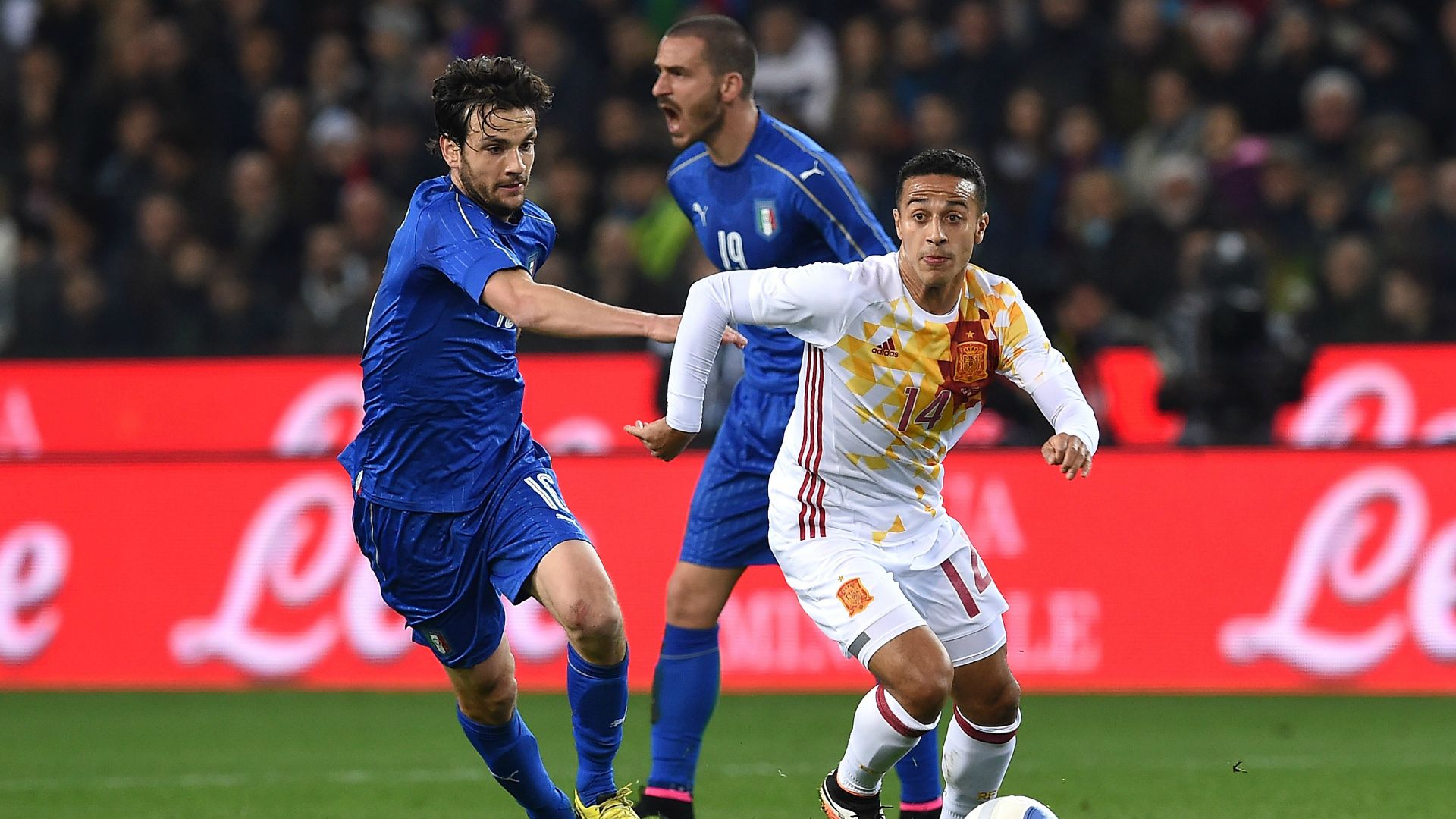 Thiago Alcantara chased by Marco Parolo Italy Spain friendly 24032016