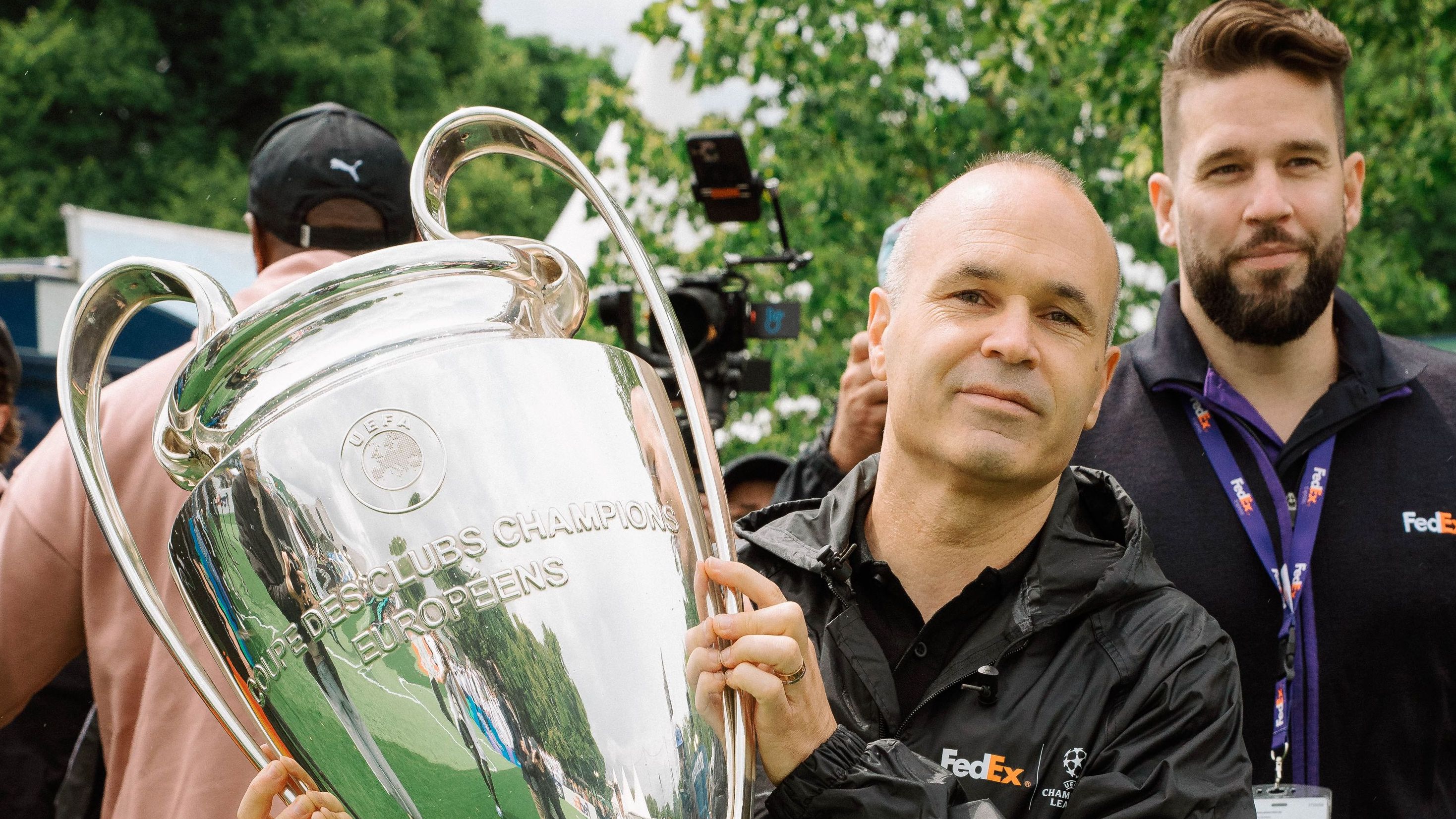 Andres Iniesta carries UEFA Champions League Trophy