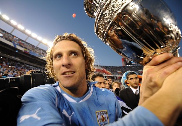 Diego Forlan holds 2011 Copa America trophy